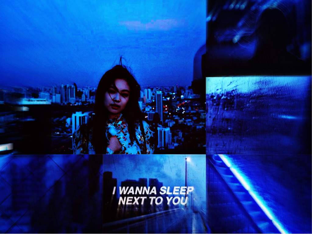 Indigo Aesthetic 桌布 壁紙 — 一幅憂鬱藍調的拼貼畫，描繪一位女士以城市景觀為背景，伴隨著雨絲和發光文字。