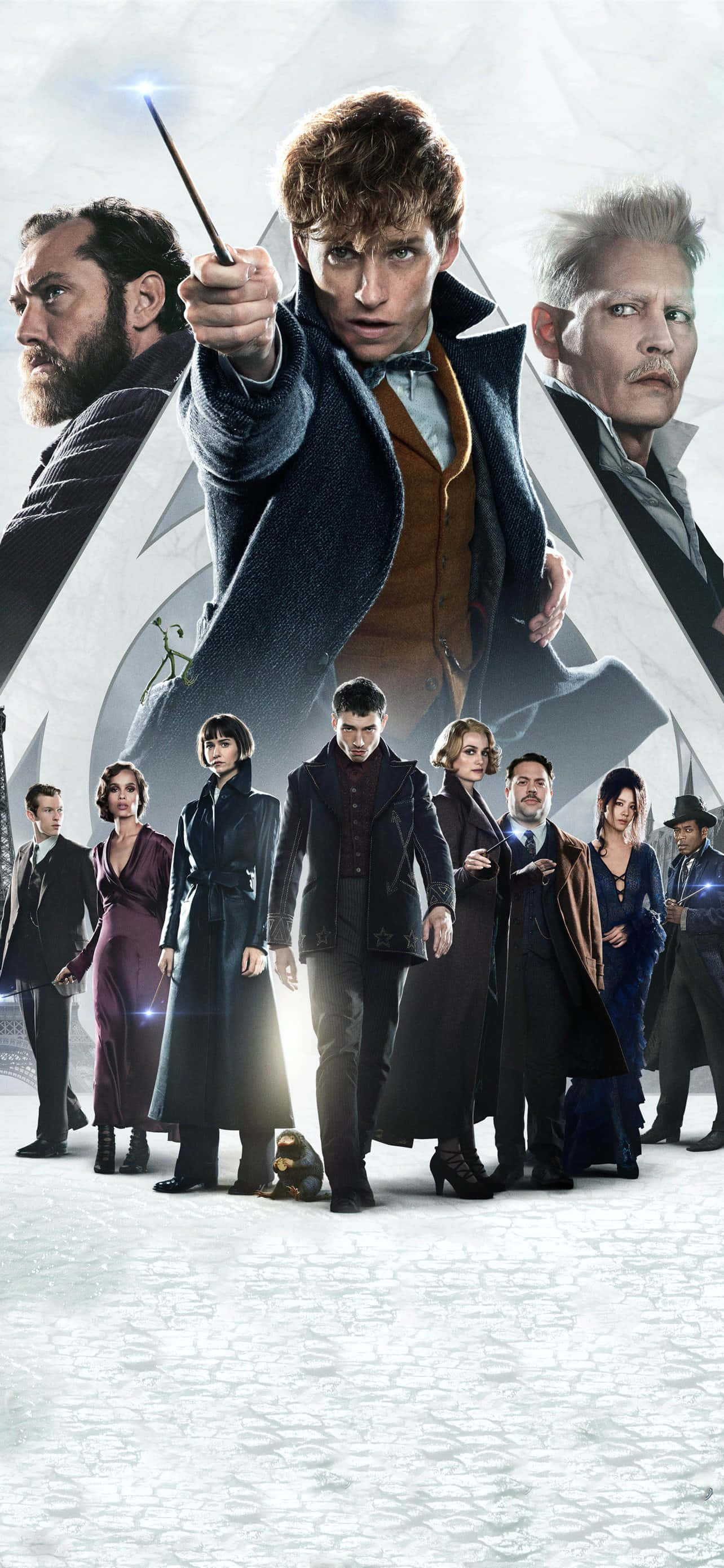Fantastic Beasts 桌布 壁紙 — 一幅戲劇性的群像，哈利波特與他的盟友身穿深色大衣，在雪景背景下手持魔杖。