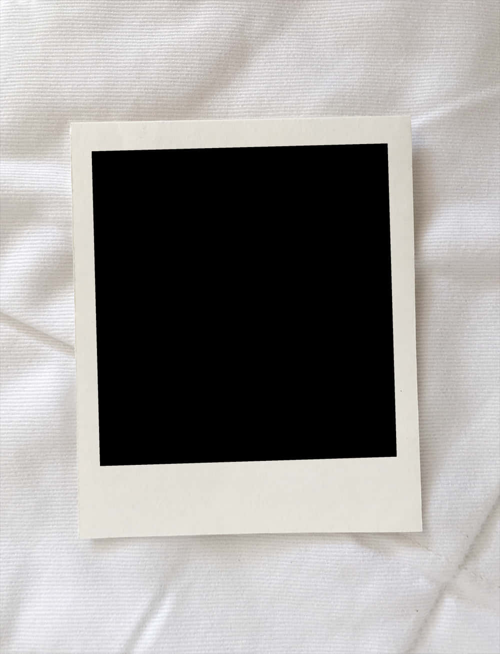 Frame 桌布 壁紙 — 一幅極簡風格的黑色相框圖片放置在帶有紋理的白色布料表面上。