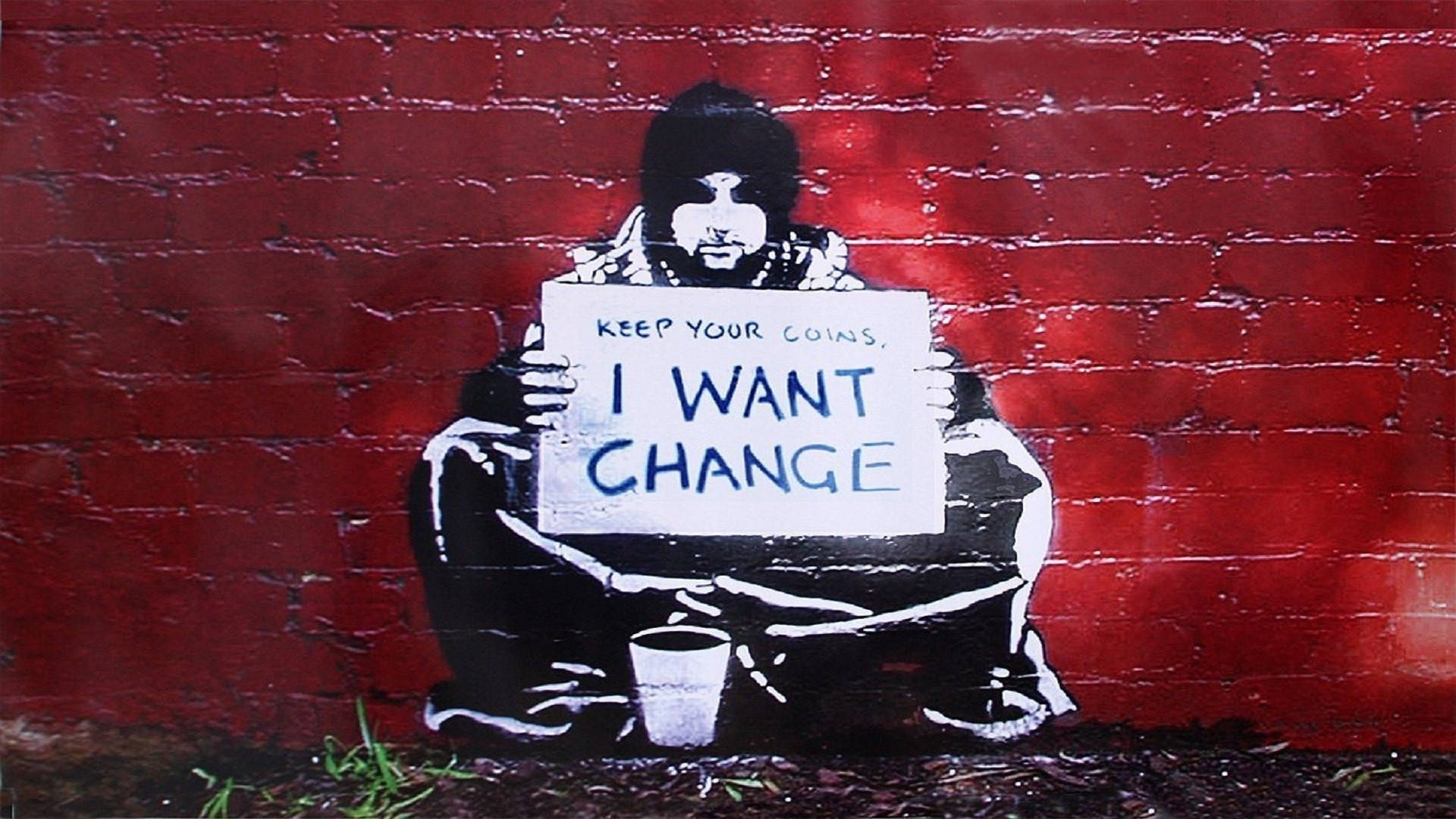 Banksy 桌布 壁紙 — 一幅模板塗鴉，描繪一個留鬍子、戴毛帽的男人，手持寫有「KEEP YOUR COINS I WANT CHANGE」的標語牌，背景是紅磚牆。