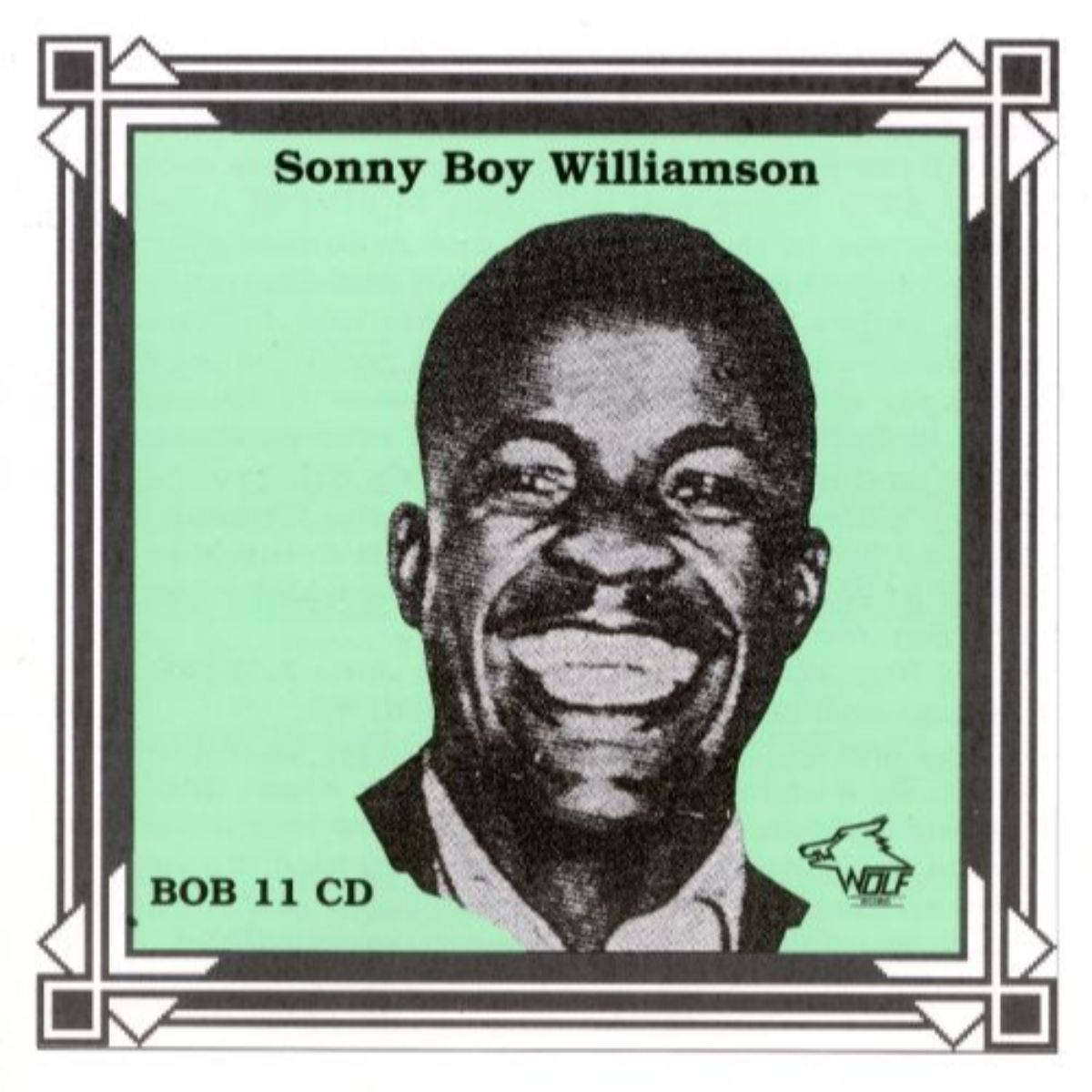 artist 桌布 壁紙 — 一幅歡樂的黑白半色調肖像，Sonny Boy Williamson 在薄荷綠色背景上微笑，帶有裝飾邊框。