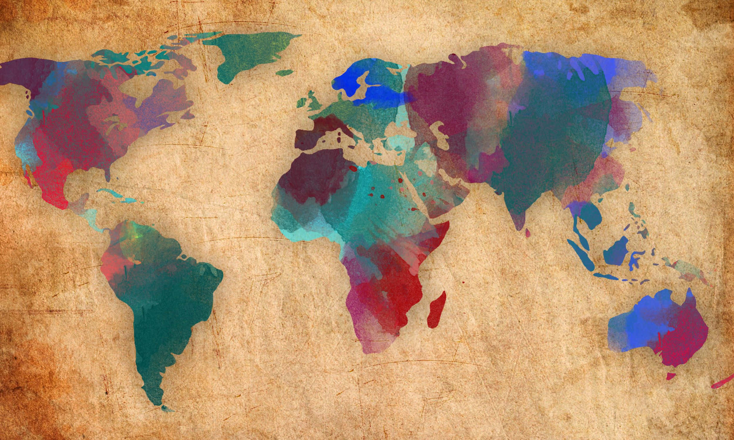 World 桌布 壁紙 — 一幅水彩世界地圖，在仿舊羊皮紙紋理上帶有鮮豔的色彩飛濺。