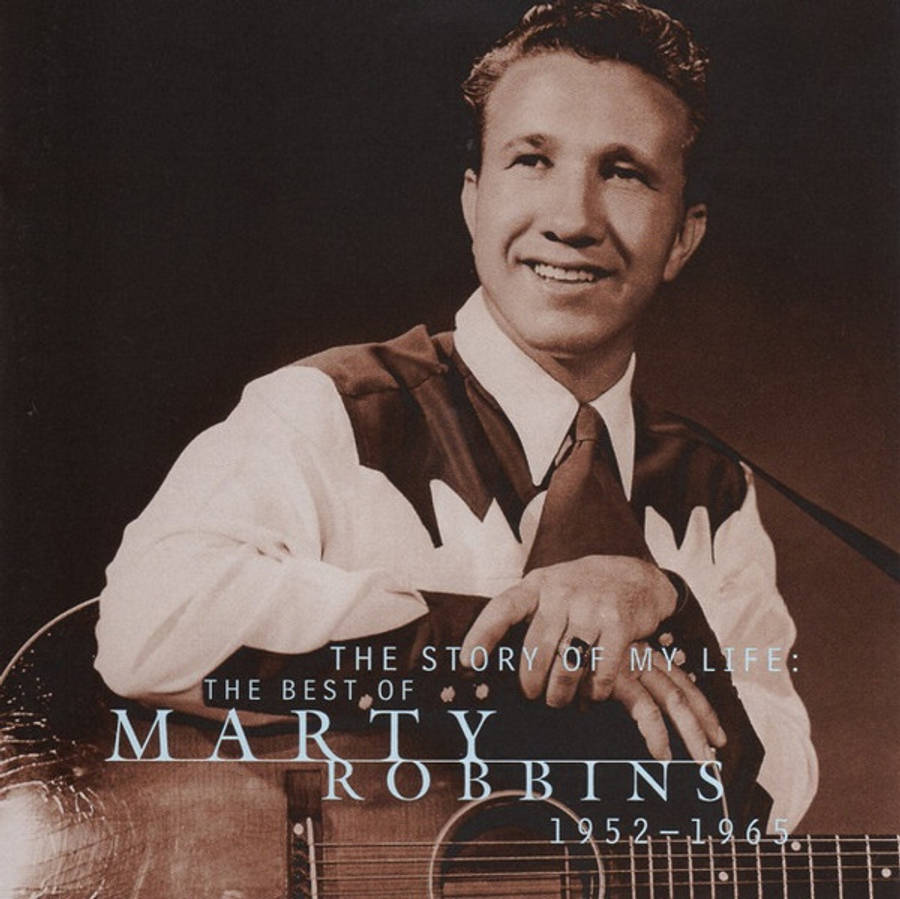 音樂 桌布 壁紙 — 一幅深褐色調的肖像，Marty Robbins 溫暖微笑，手持原聲吉他，背景為深色錄音室。