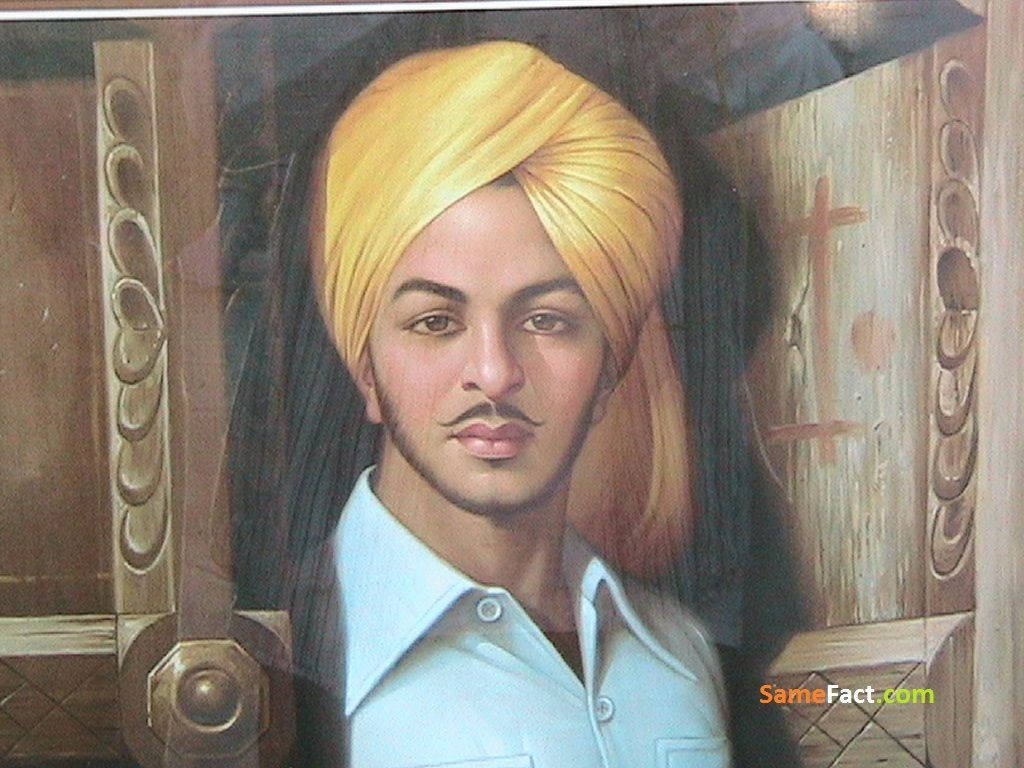 Shaheed Bhagat Singh 桌布 壁紙 — 一幅男人肖像，戴著金色頭巾和鬍鬚，穿著淺藍色襯衫，背景是木門。