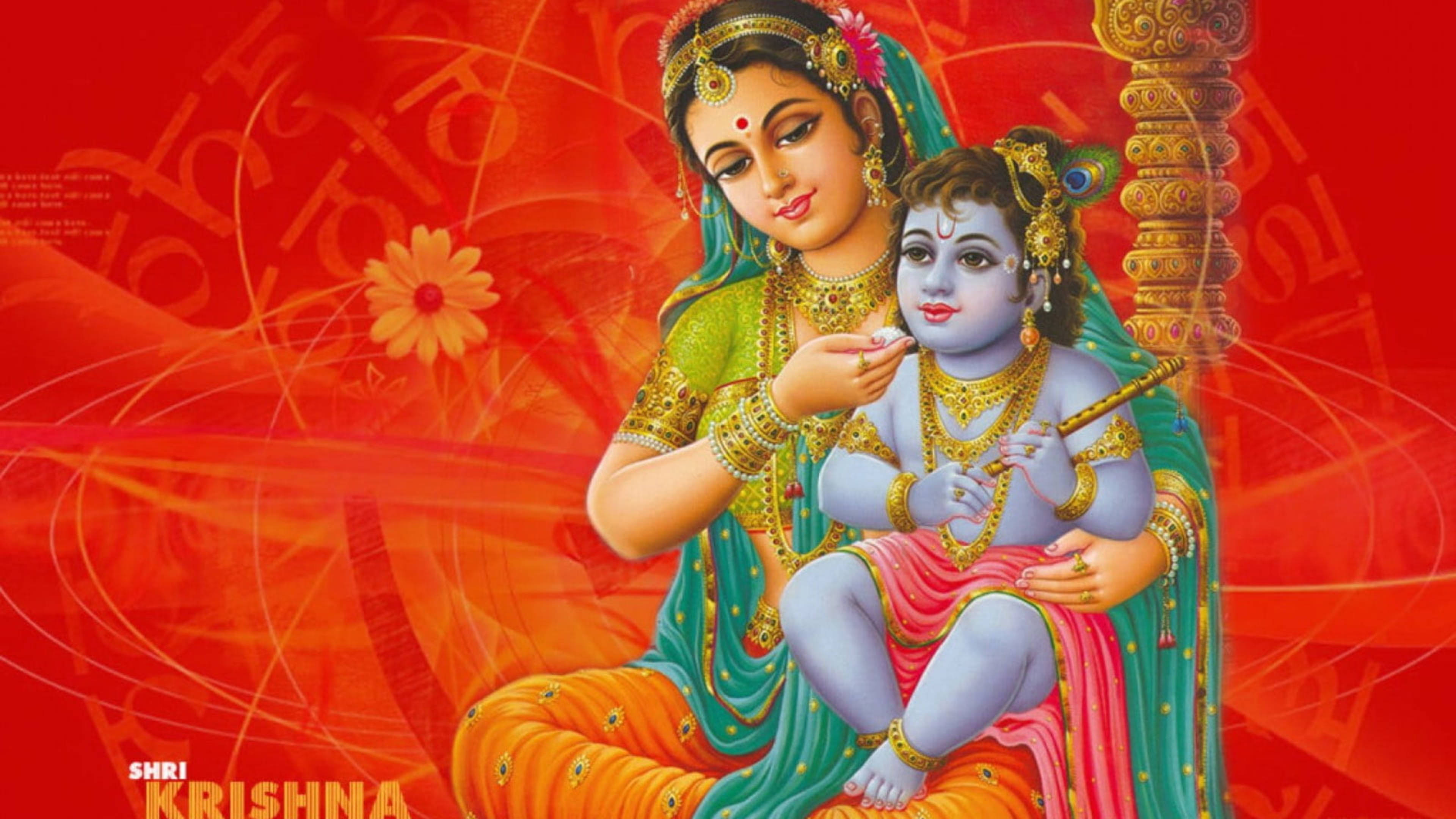 krishna ji 桌布 壁紙 — 一幅神聖的插圖，描繪母親雅首達懷抱嬰兒克里希納，他在吹奏笛子，背景是鮮豔的紅色，帶有花卉和文字圖案。