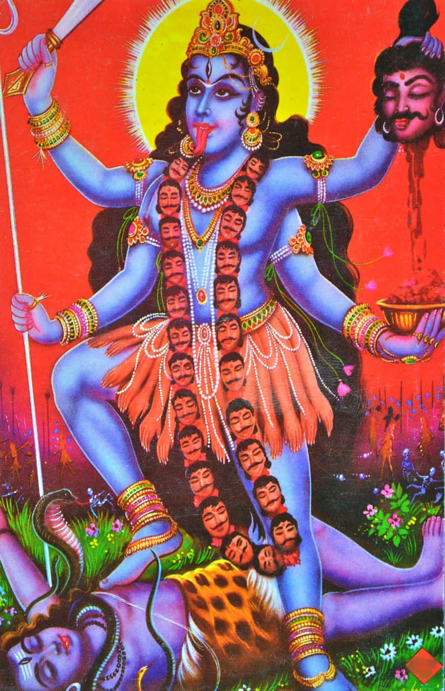 Hindu God 桌布 壁紙 — 一幅色彩鮮明的藍皮膚印度教神祇畫像，有多隻手臂和多個頭顱，飾以珠寶，手持武器和一個被斬下的頭顱，坐在被殺的惡魔身上，背景是火紅色的。