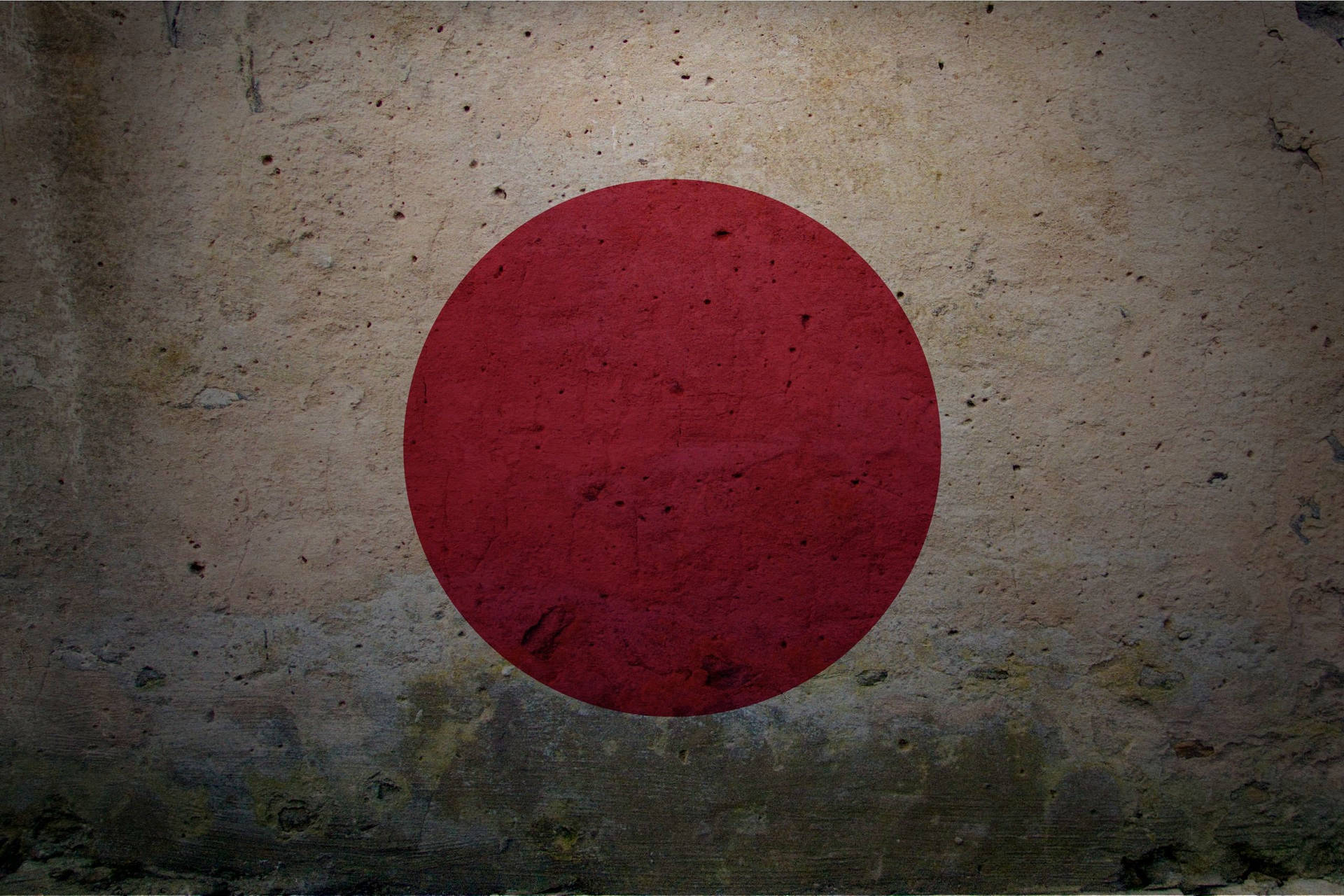 日本國旗繪在風化的混凝土牆上，有明顯裂縫和污漬。