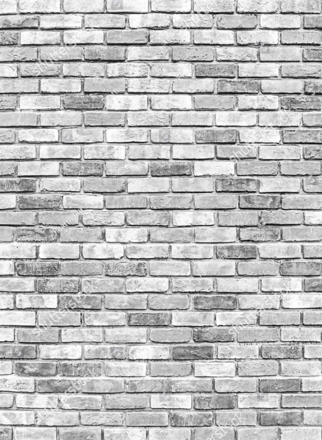 wall 桌布 壁紙 — 一幅風化灰色磚牆的特寫，色調多變，灰泥線條營造出質樸的城市紋理。