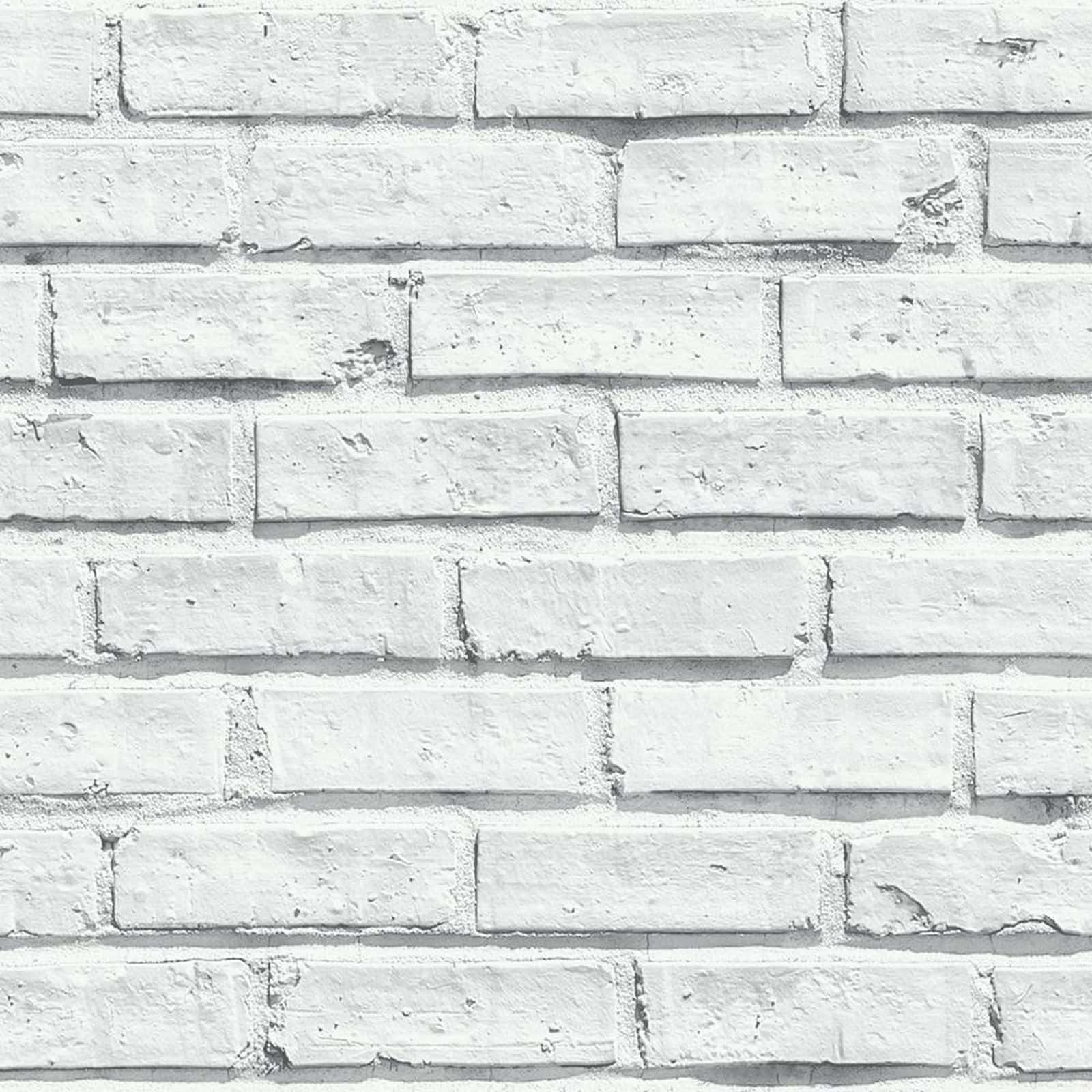 White Brick Wall 桌布 壁紙 — 一幅風化白色磚牆的特寫，帶有可見紋理和細微陰影。