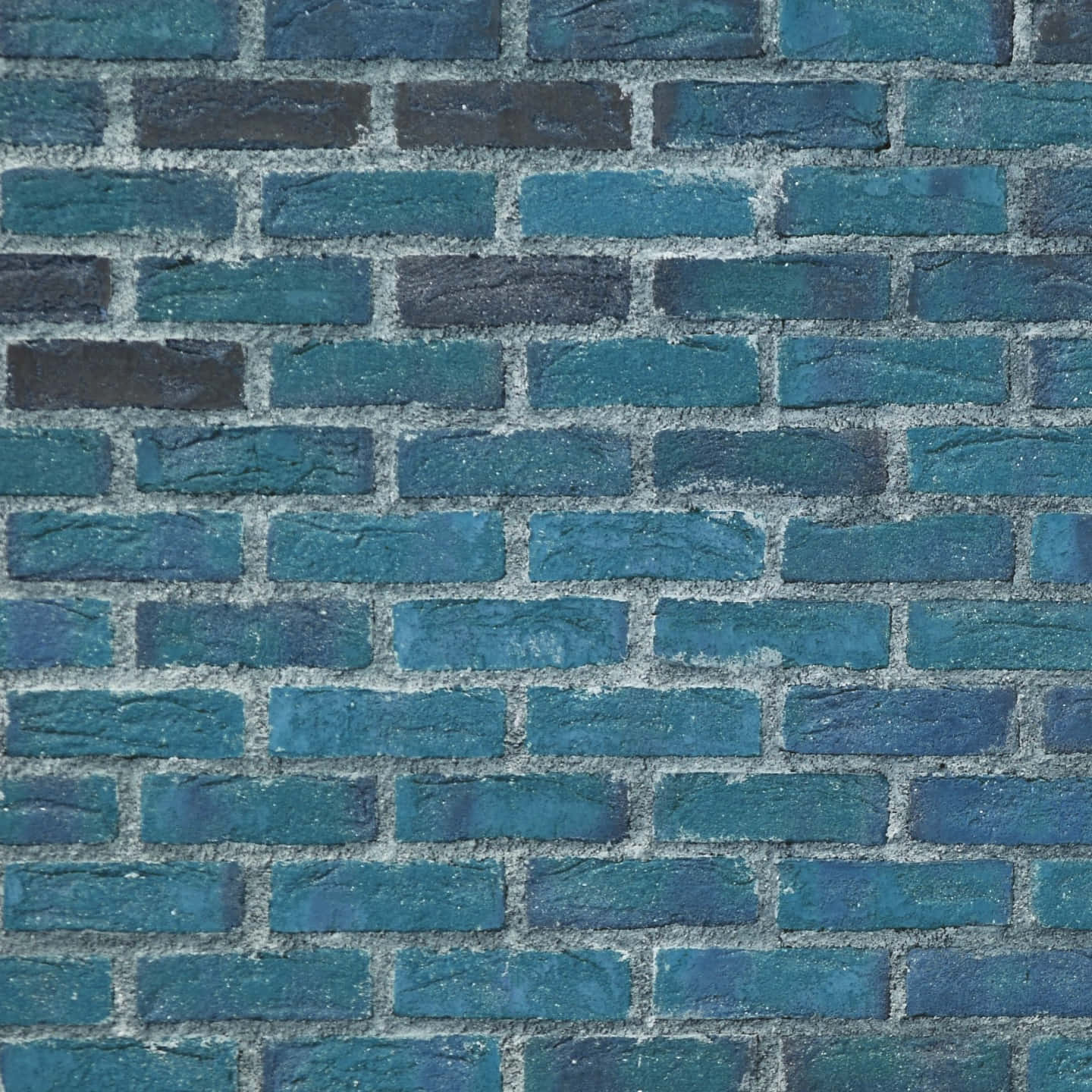 Brick 桌布 壁紙 — 一幅風化磚牆的特寫，塗有不同深淺的藍綠色和深藍色，帶有灰色砂漿。
