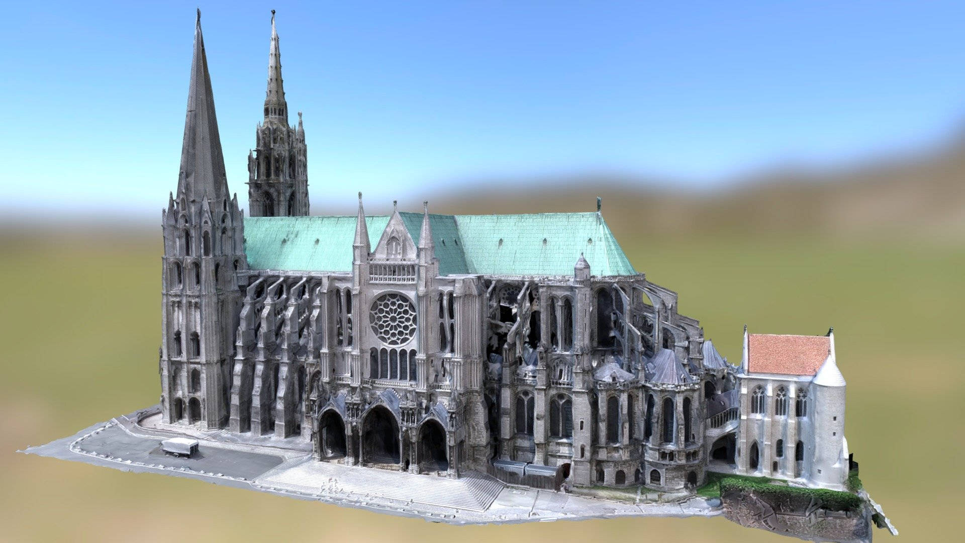 3D 桌布 壁紙 — 一座3D渲染的哥德式大教堂，擁有綠色屋頂和石製尖塔，部分廢墟狀態，背景是模糊的草地和晴朗的藍天。