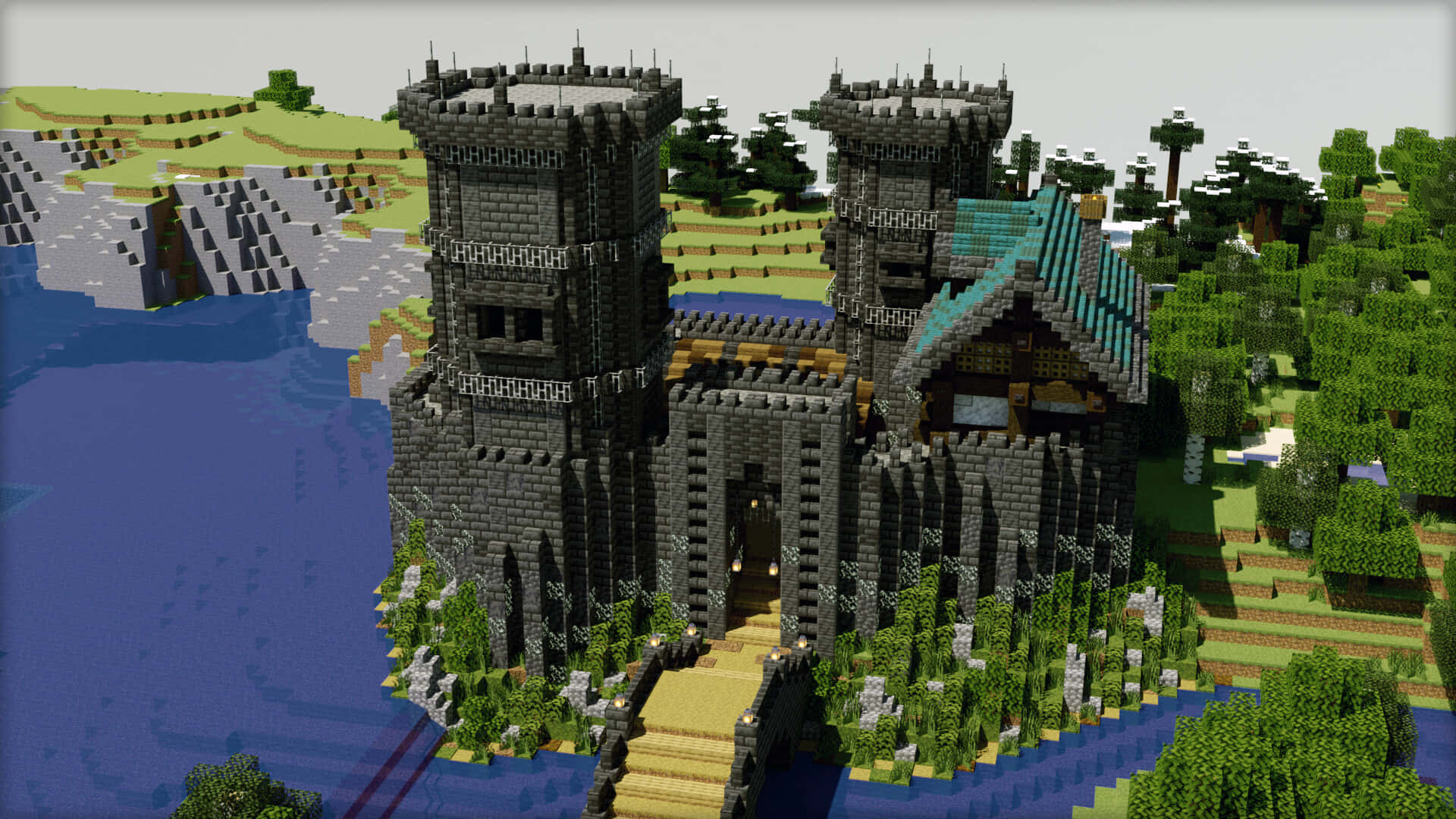 Minecraft Castles 桌布 壁紙 — 一座像素化的中世紀城堡，擁有灰色石塔和青綠色屋頂，坐落在河岸上，周圍環繞著綠樹和起伏的山丘。