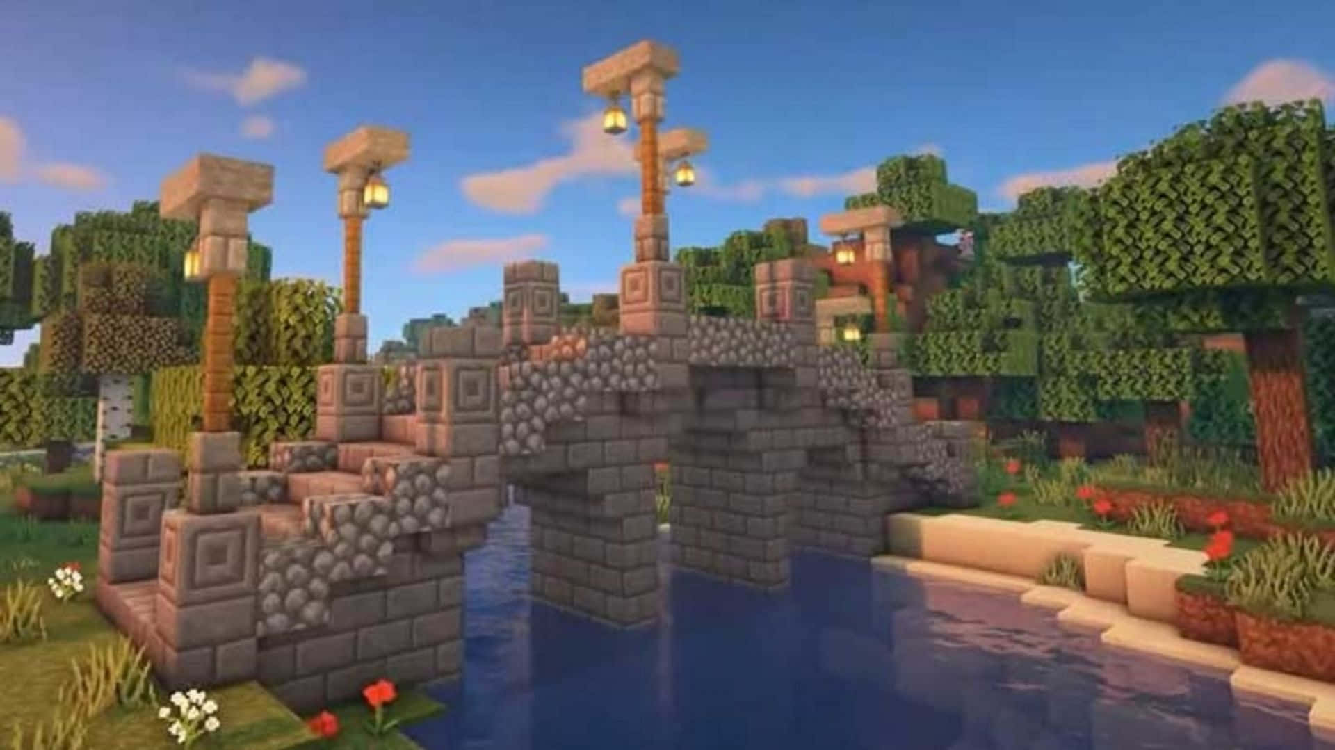 Minecraft Bridges 桌布 壁紙 — 一座像素化的石橋，帶有發光的燈籠，橫跨一條平靜的河流，周圍是方塊狀的樹木和花朵，在明亮的藍天下。