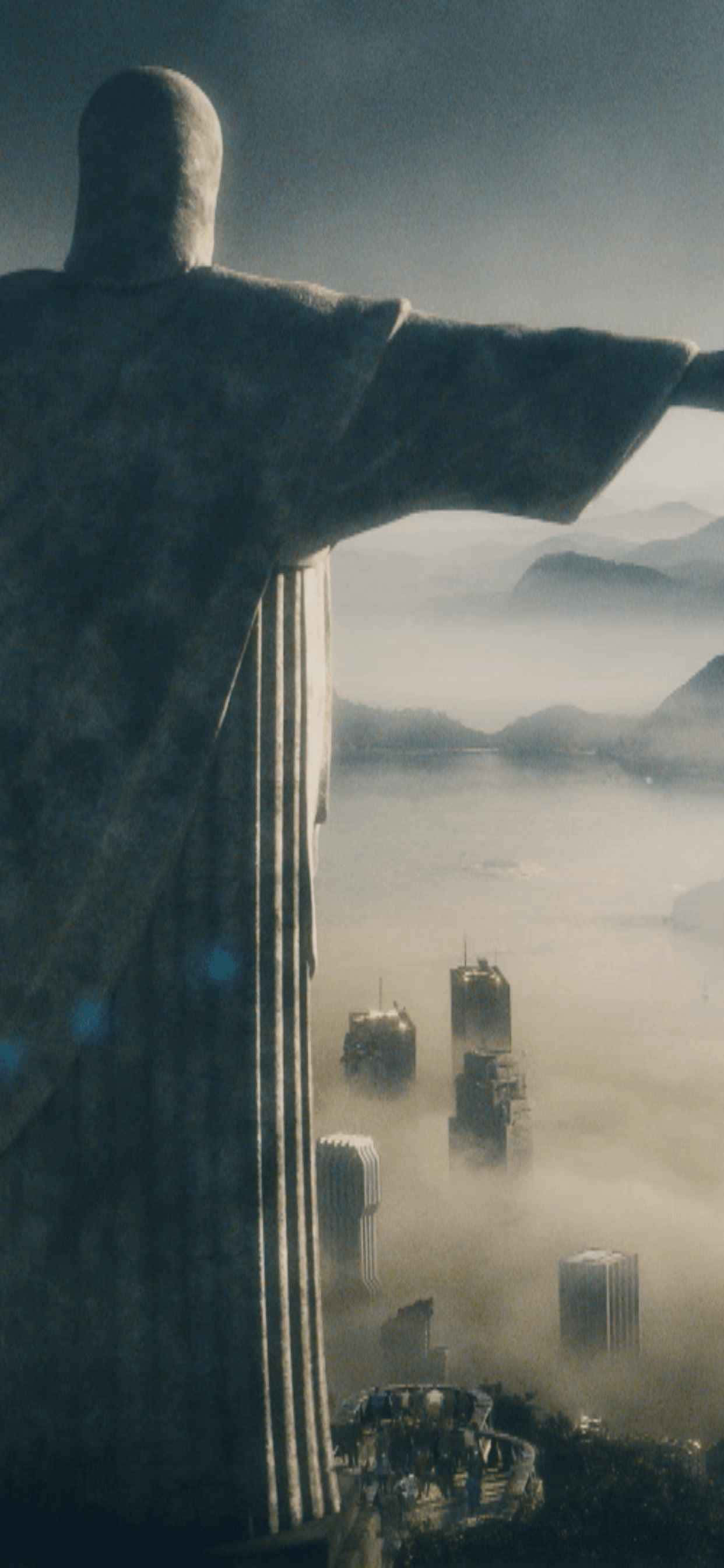 一座基督雕像，背景為城市 壁紙