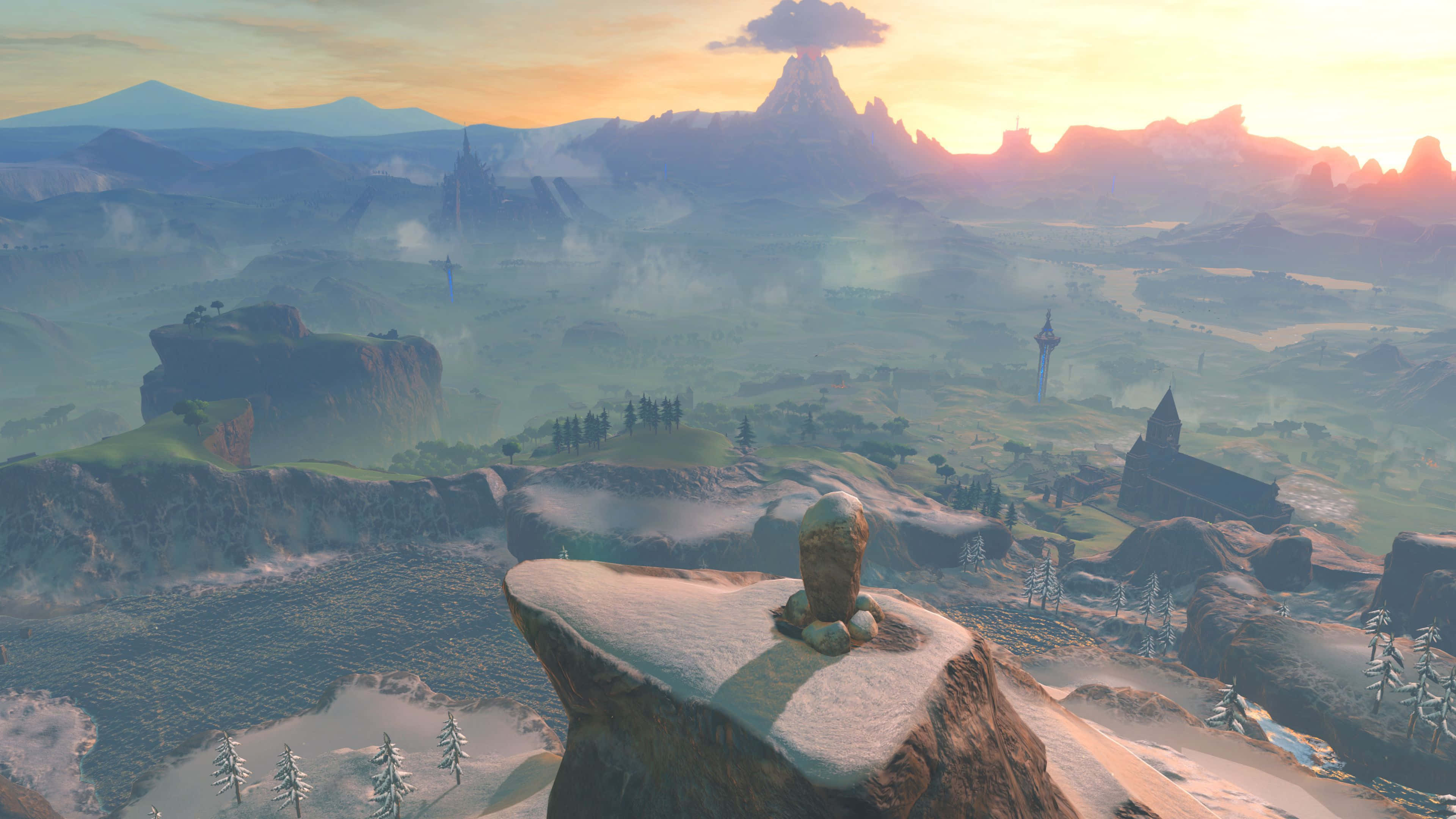 Breath Of The Wild 桌布 壁紙 — 一座孤獨的石像俯瞰著廣闊的霧谷，夕陽西下，遠山和古塔在溫暖發光的天空下。