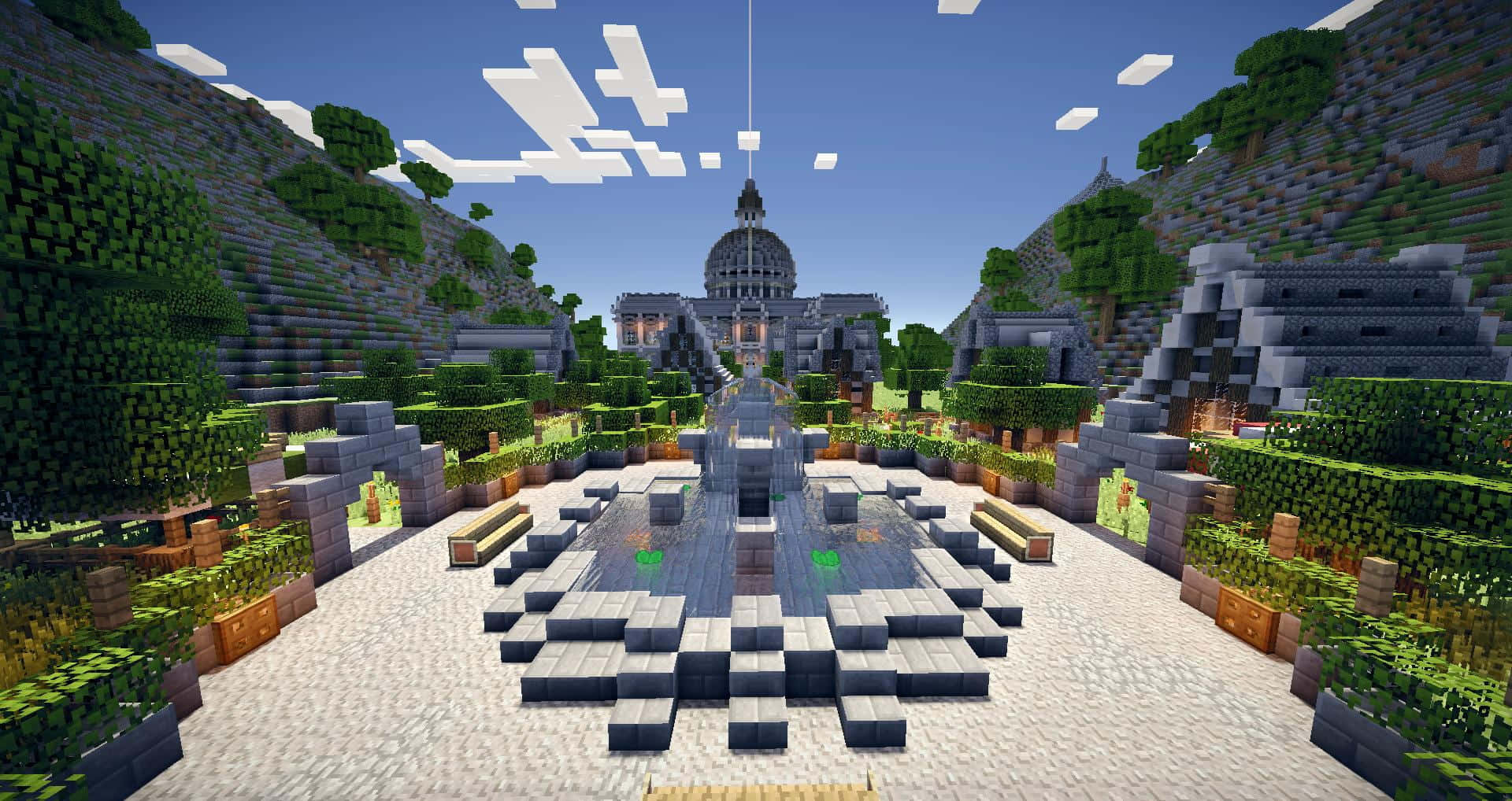 Minecraft Server 桌布 壁紙 — 一座宏偉的Minecraft神廟，中央有噴泉，坐落在鬱鬱蔥蔥的綠色山丘之間，上方是明亮的藍天，點綴著方塊狀的雲朵。