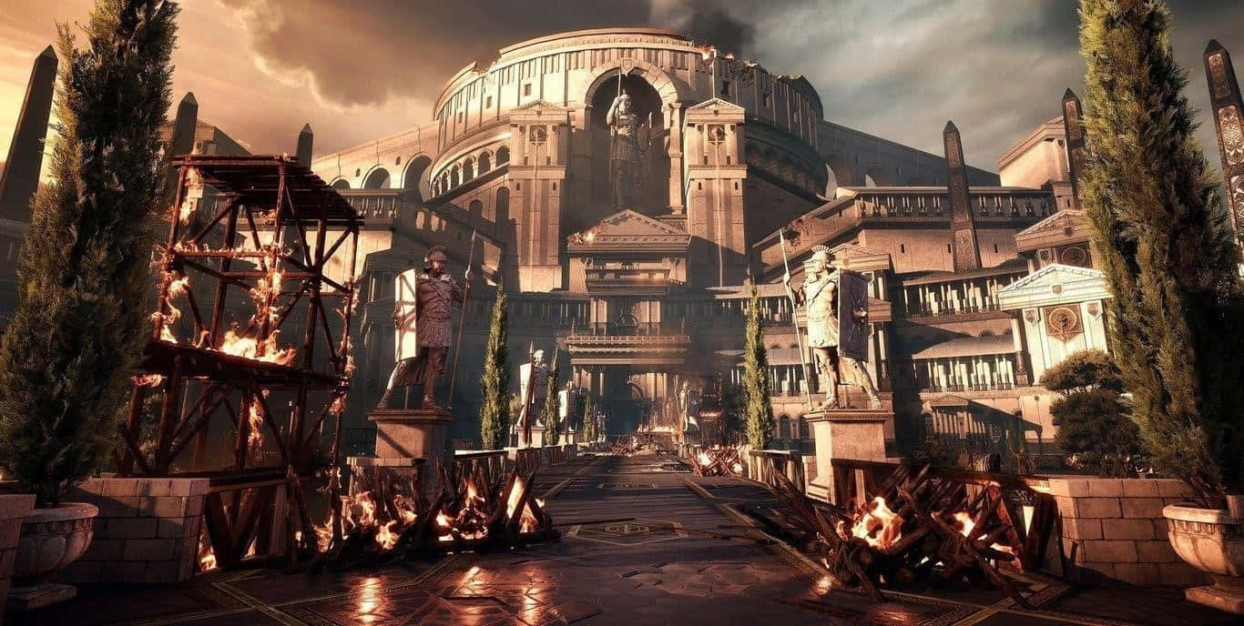 Rome 桌布 壁紙 — 一座宏偉的古代競技場聳立在火熱的競技場上，兩旁有雕像和柏樹，背景是戲劇性的日落天空。