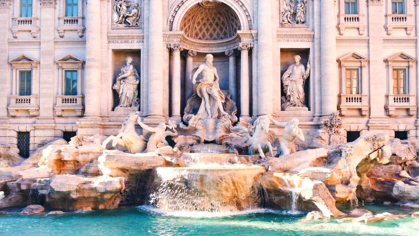 Italy Aesthetic 桌布 壁紙 — 一座宏偉的巴洛克式噴泉，帶有大理石雕像和層疊流水，以歷史建築立面為背景。