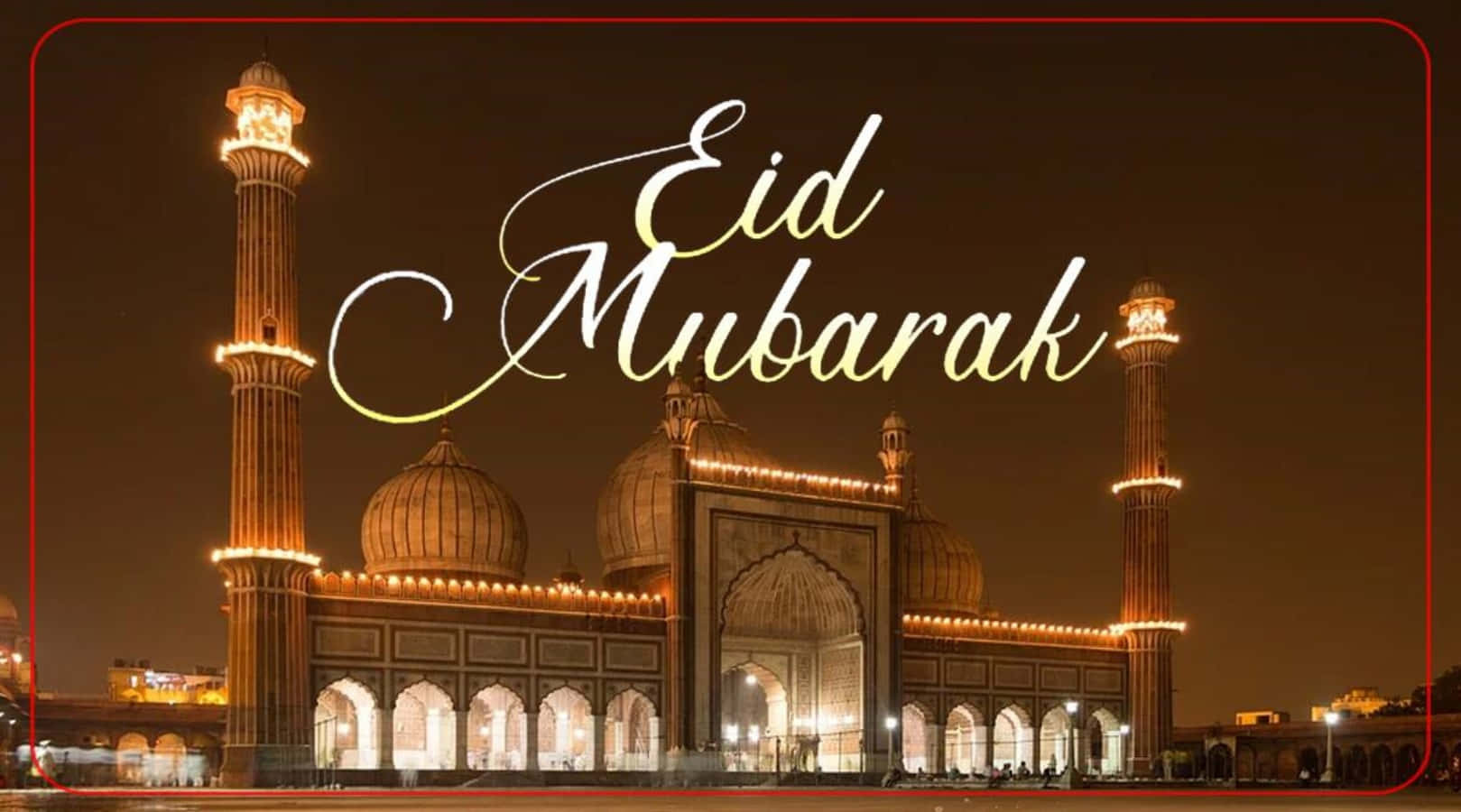 Eid 桌布 壁紙 — 一座宏偉的清真寺在夜晚被照亮，閃耀的宣禮塔和圓頂在黑暗的天空下，以優雅的金色書寫著「Eid Mubarak」。