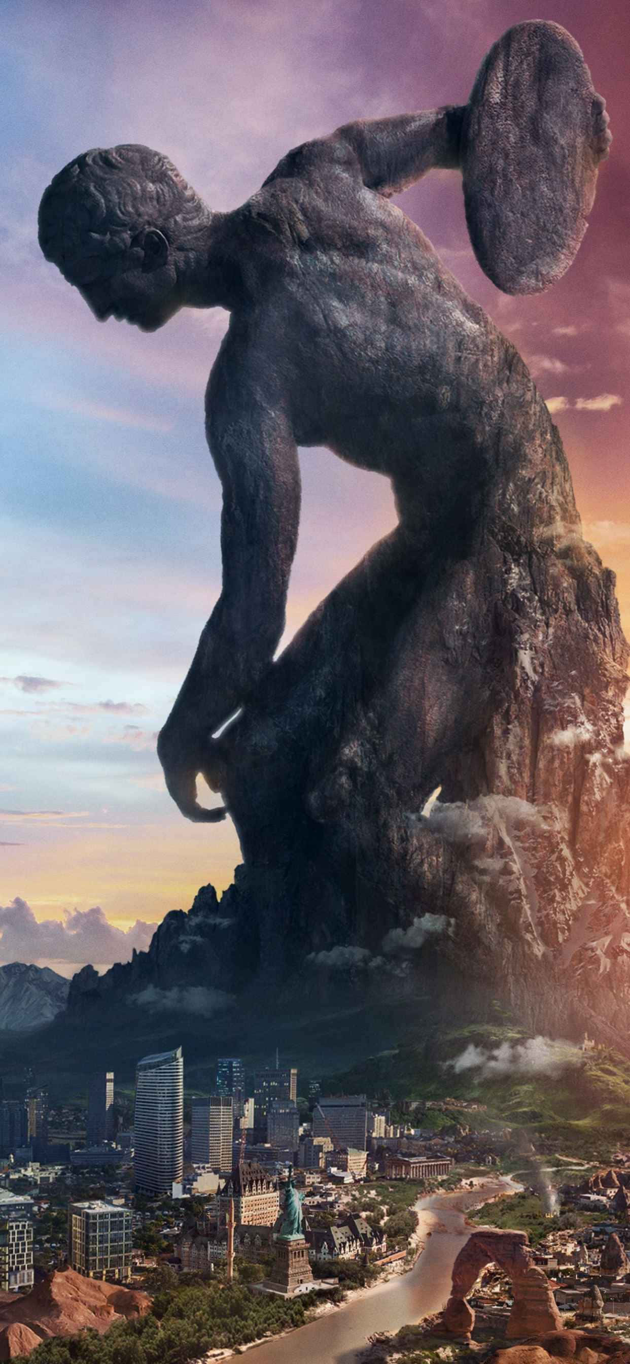 iPhone Xs Max Civilization V 桌布 壁紙 — 一座巨大的擲鐵餅者石像，在日落時分俯瞰著城市景觀，主宰著山區景色。