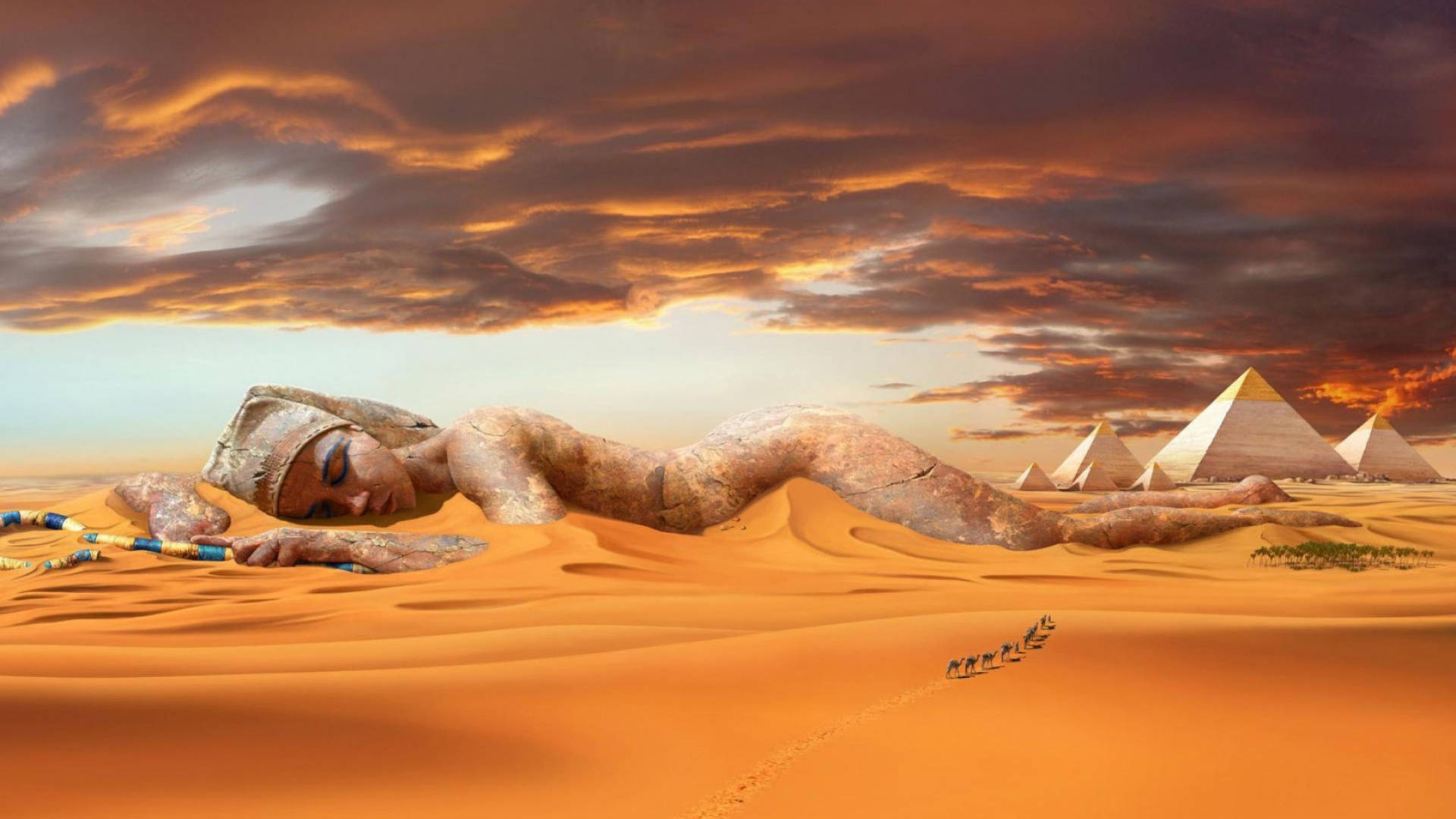 Cleopatra 桌布 壁紙 — 一座巨大的石像，一位寧靜的女人躺在沙漠沙丘景觀中沉睡，遠處有金字塔和商隊，在熾熱的日落天空下。