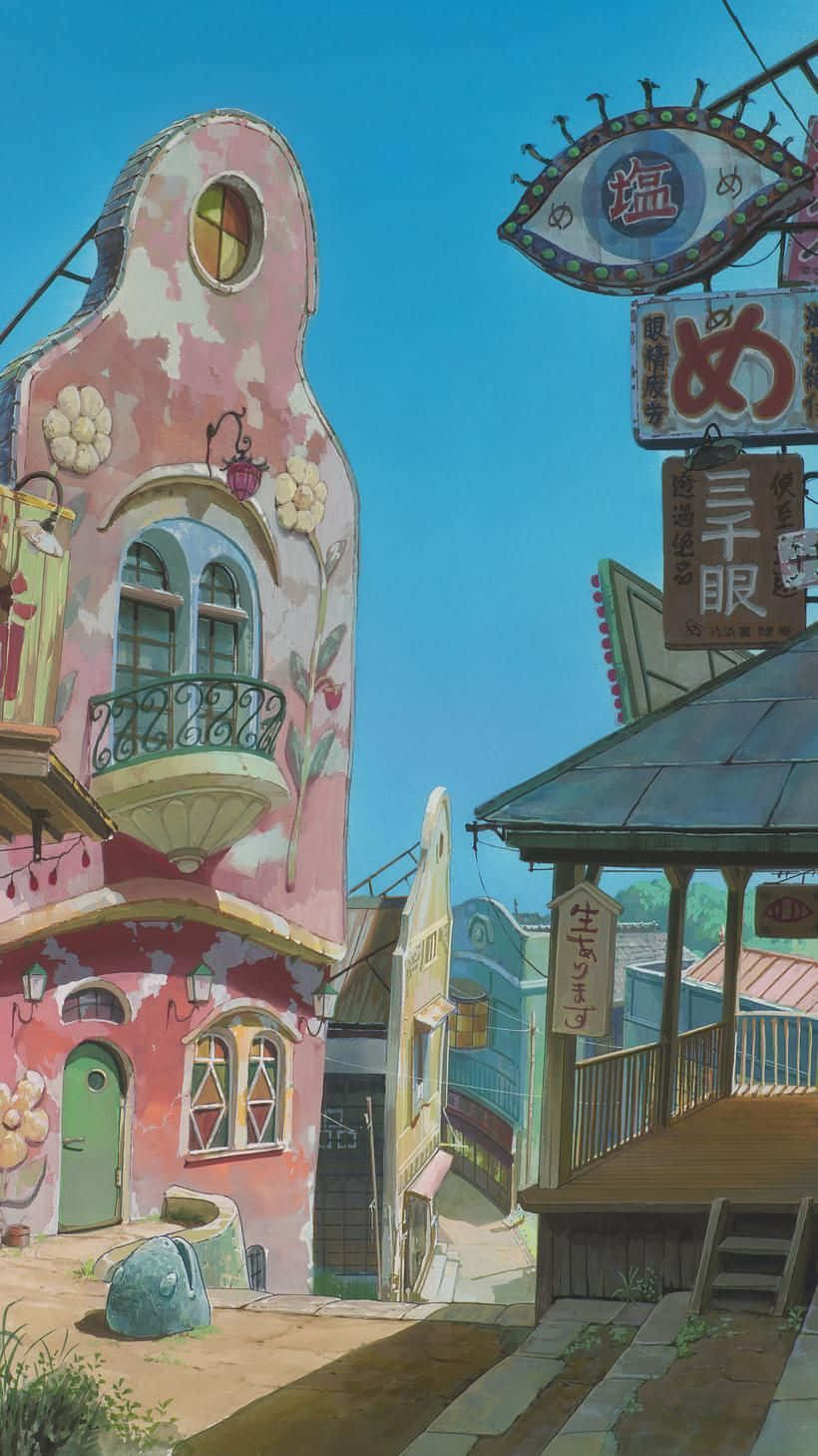  壁紙 — 一座帶有花卉裝飾和日語招牌的夢幻粉色建築，矗立在晴朗藍天下陽光普照的小巷中。