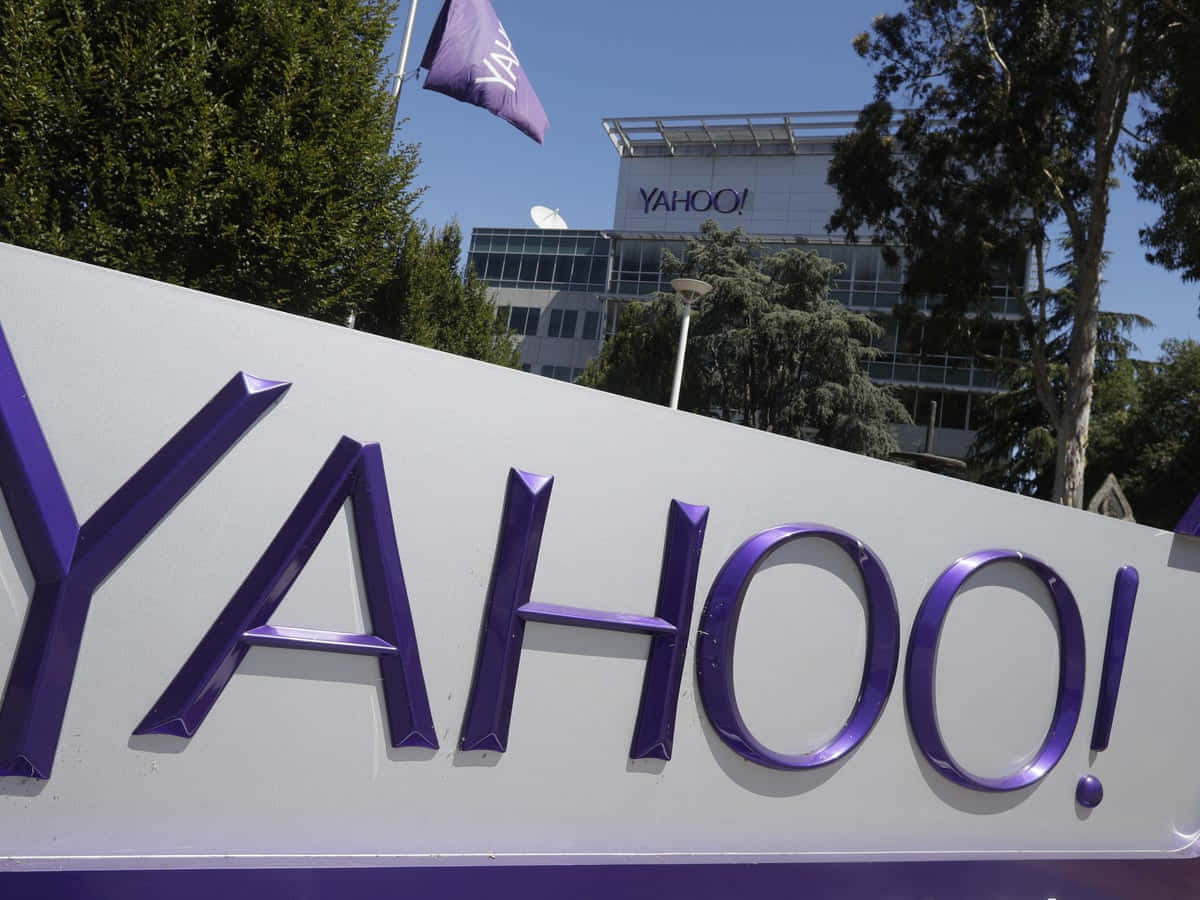 辦公大樓前有樹木和藍天的Yahoo企業標誌。 — Valorant Logo 壁紙