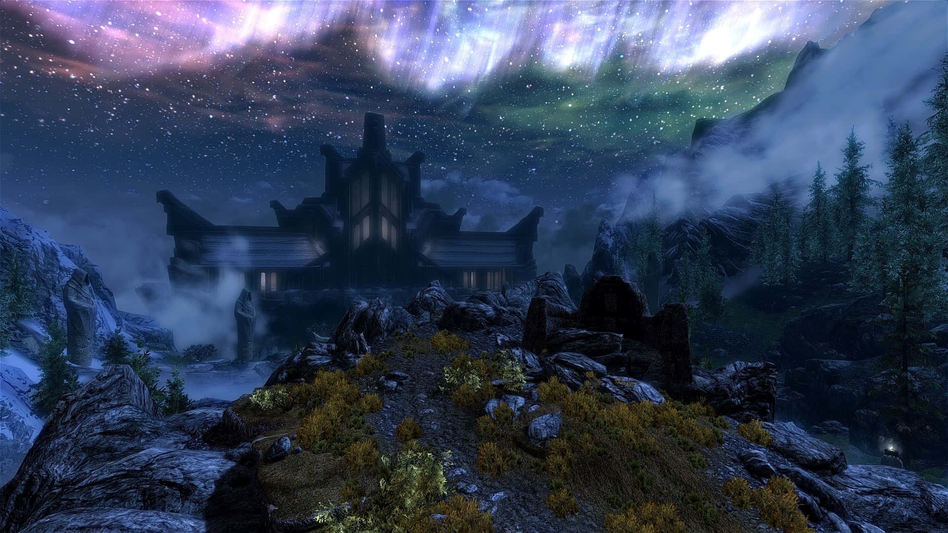 Sovngarde 桌布 壁紙 — 一座神秘的石頭城堡坐落在白雪覆蓋的山脊上，下方是充滿活力的北極光和星空。