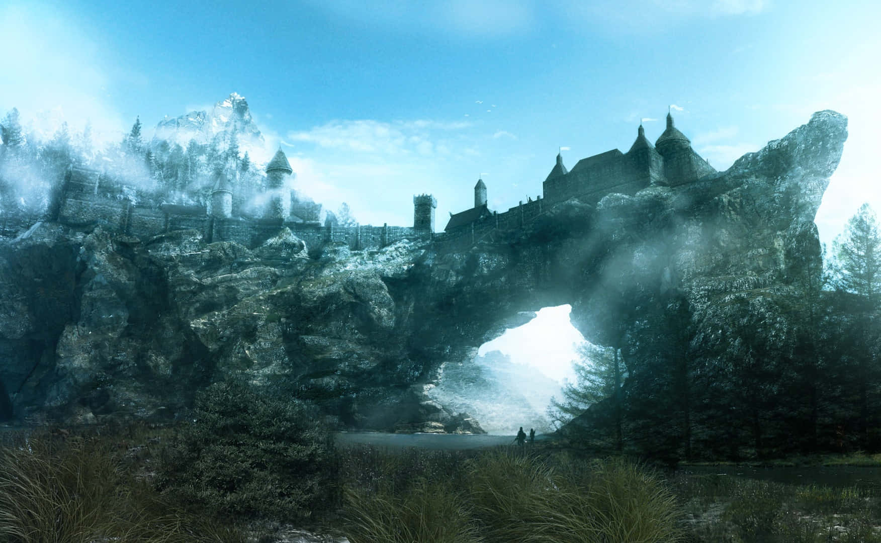 Skyrim Landscapes 桌布 壁紙 — 一座雄偉的中世紀城堡坐落在霧氣繚繞的懸崖上，發光的拱門顯露出背後明亮的光芒。