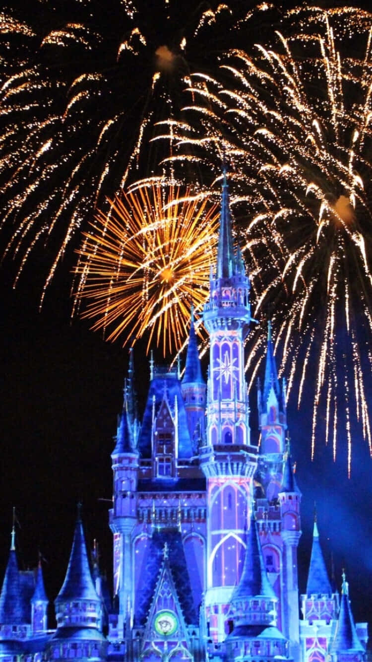 Disneyland Castle 桌布 壁紙 — 一座雄偉的藍色城堡在黑暗的夜空中綻放金色煙火。