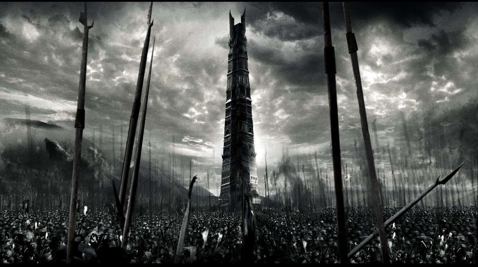 Lotr 桌布 壁紙 — 一座高聳的黑暗尖塔從長矛戰場上升起，背景是風暴般的單色天空。