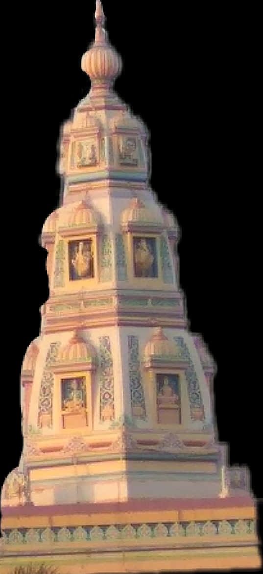 Hindu Temple 桌布 壁紙 — 一座高聳華麗的寺廟塔樓，帶有精緻的雕刻和雕像，沐浴在溫暖的金色光芒中，背景為黑色。