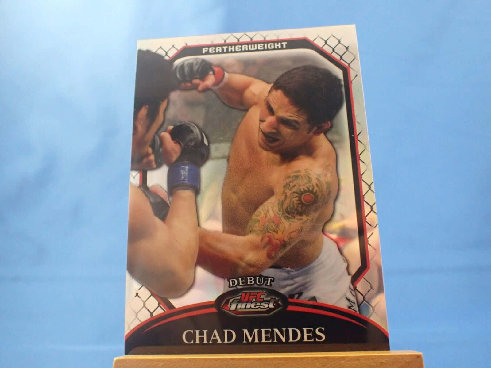 MMA 桌布 壁紙 — 一張UFC拳手卡， featuring Chad Mendes 在羽量級比賽中，紋身清晰可見，背景為藍色。