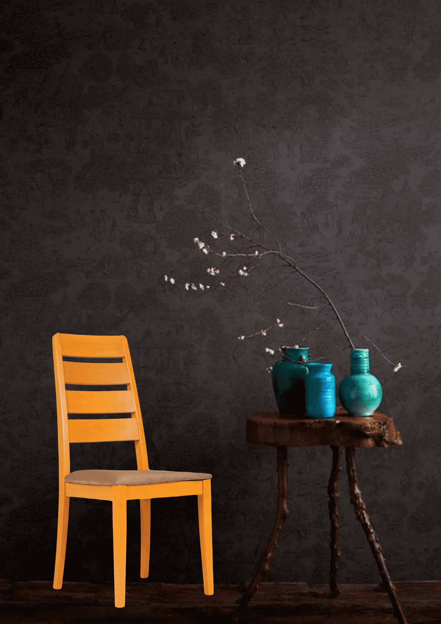 chair 桌布 壁紙 — 一張充滿活力的橙色椅子放在一張質樸的木桌旁，桌上擺放著青綠色花瓶，插著精緻的白色花朵，背景是深色紋理牆壁。