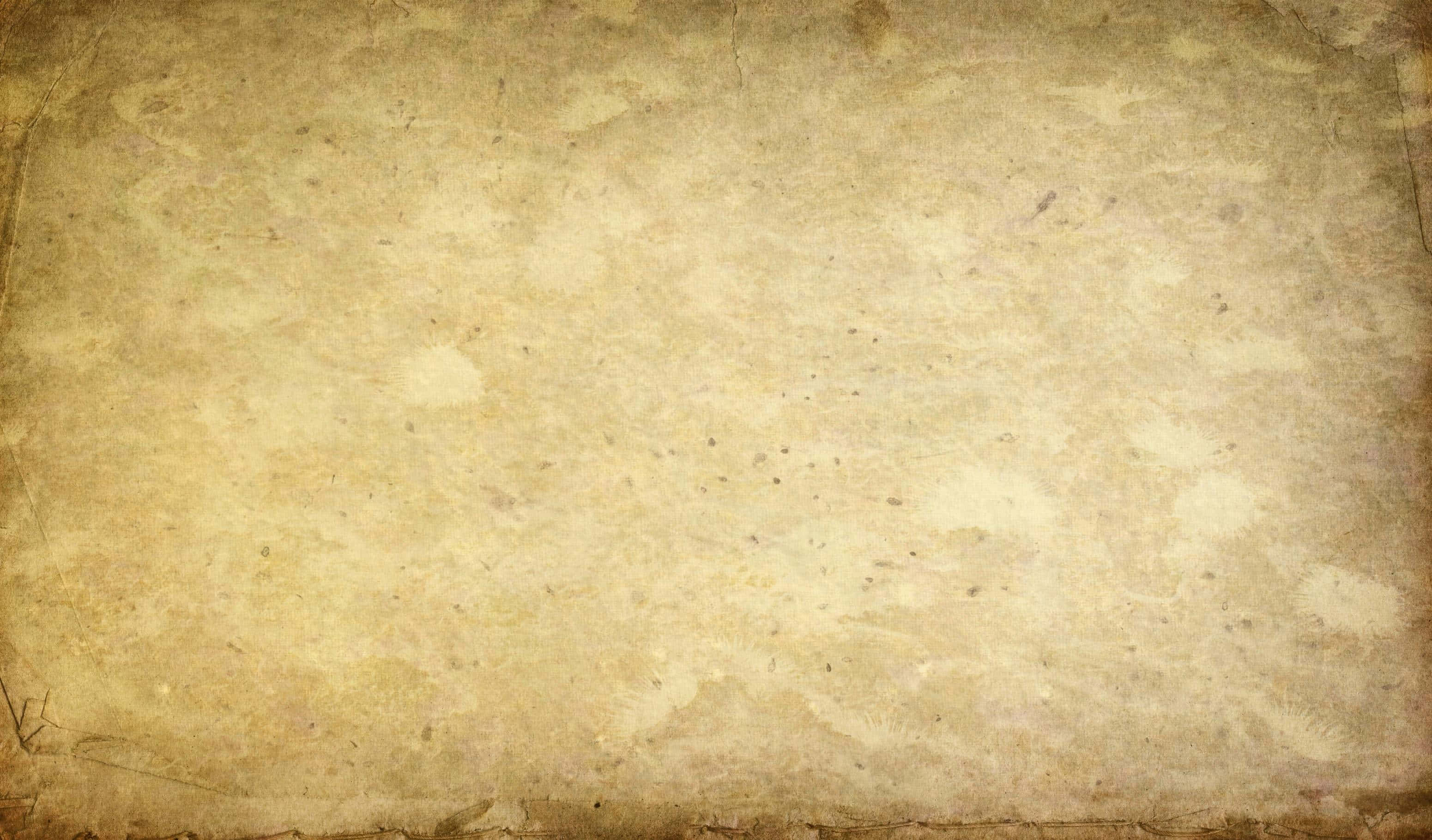 Old Paper 桌布 壁紙 — 一張古舊羊皮紙，帶有不均勻的米色調和細微污漬，營造出復古紋理背景。