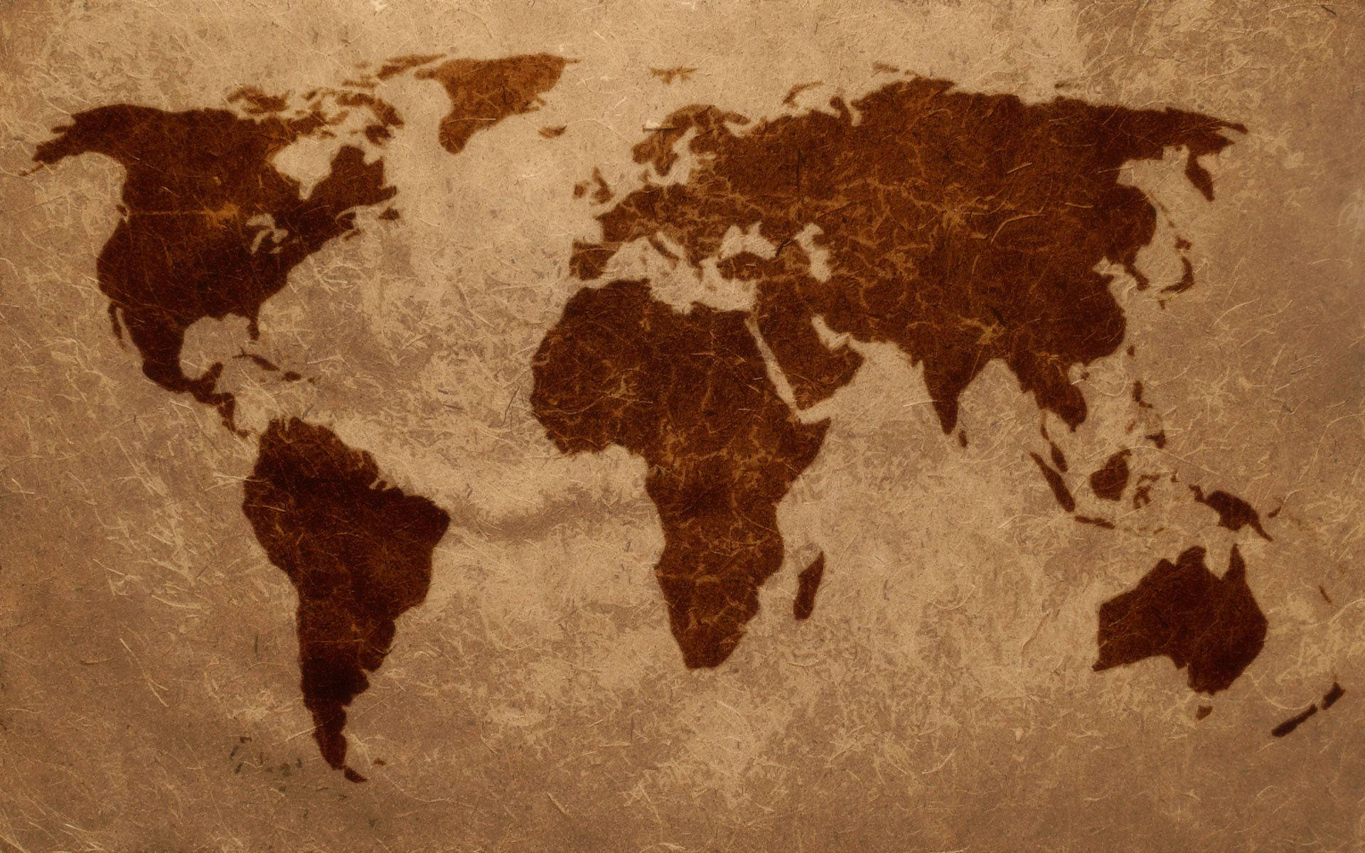 World 桌布 壁紙 — 一張復古世界地圖，深棕色大陸印在紋理米色紙上，喚起探索與歷史感。