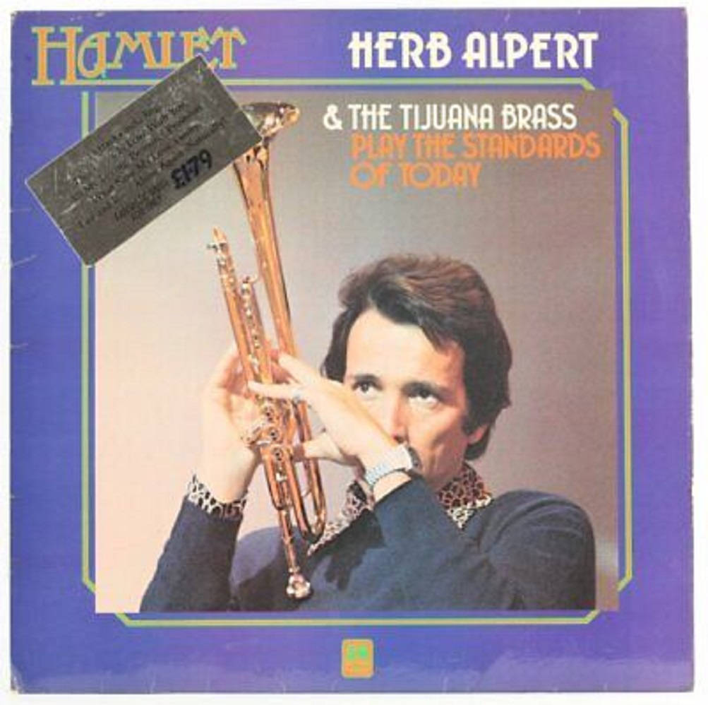 Album Cover 桌布 壁紙 — 一張復古專輯封面顯示 Herb Alpert 在紫色背景上拿著小號，並配有粗體文字。