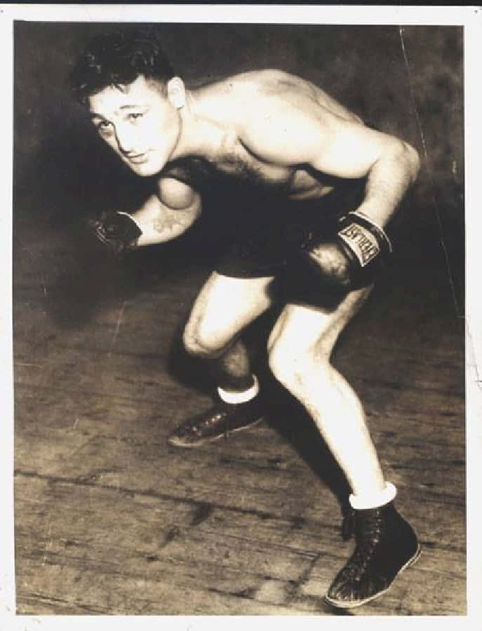 Boxing 桌布 壁紙 — 一張復古黑白照片，展示一位肌肉發達的拳擊手在木地板上擺出戰鬥姿勢。