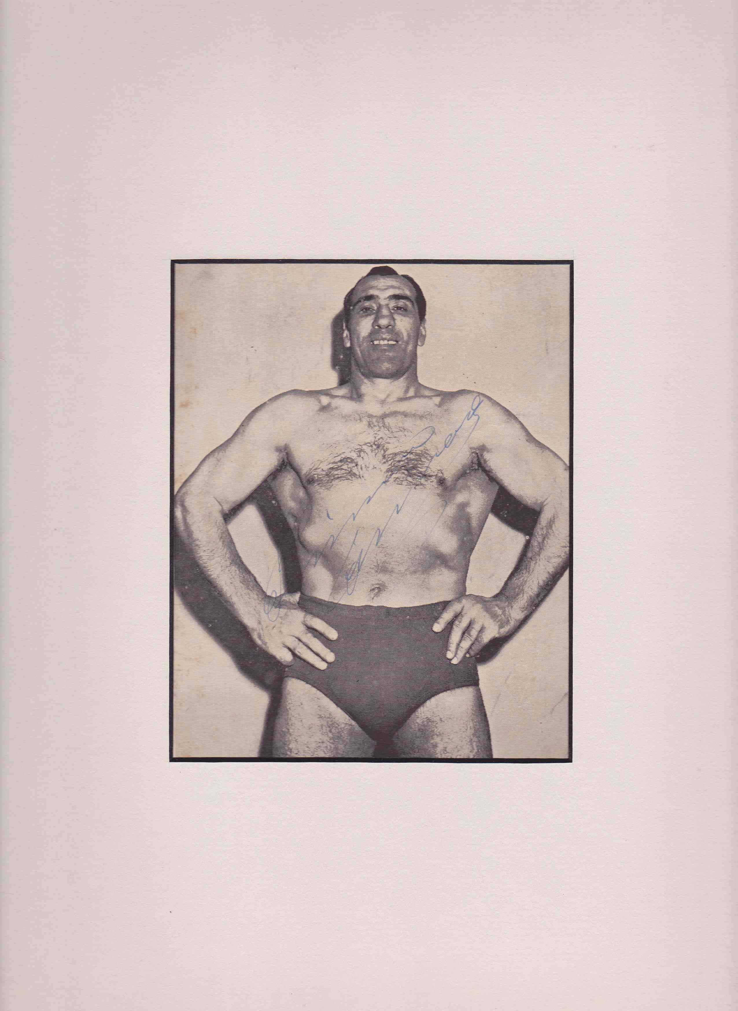 摔角 桌布 壁紙 — 一張復古黑白肖像，展示一位肌肉發達的男子穿著摔角短褲，雙手叉腰自信地擺姿勢。