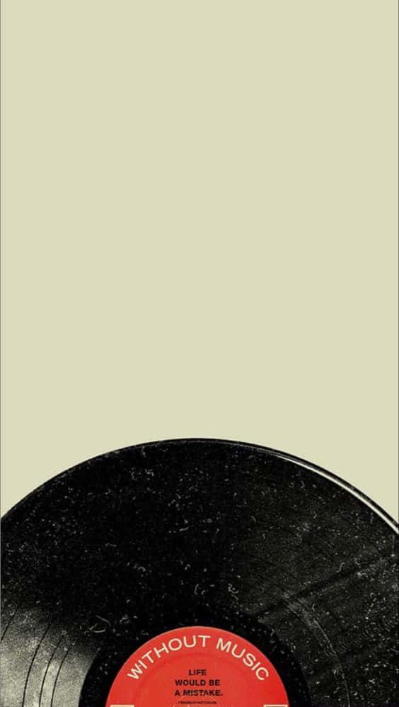Vinyl Record 桌布 壁紙 — 一張復古黑色黑膠唱片，帶有紅色標籤，上面寫著「WITHOUT MUSIC LIFE WOULD BE A MISTAKE」，靠在淺米色背景上。