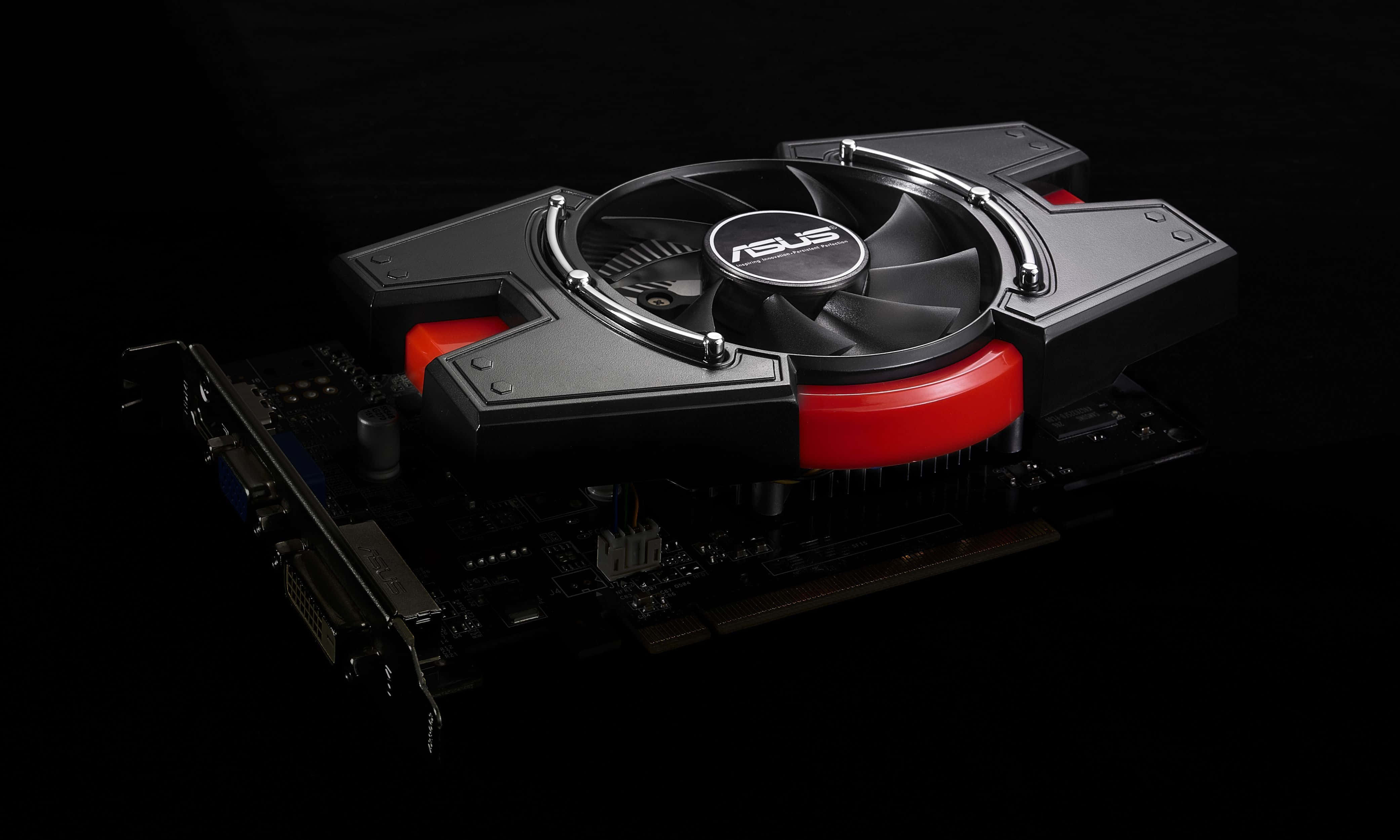 4K Graphics Cards 桌布 壁紙 — 一張時尚的ASUS顯示卡，帶有黑色和紅色點綴及中央散熱風扇，在純黑色背景上孤立展示。