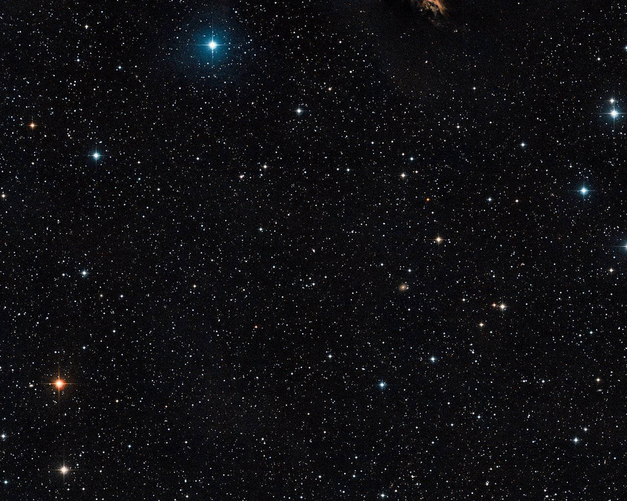 Star Space 桌布 壁紙 — 一張深空照片，在黑色宇宙背景下展示無數顆帶有鮮豔藍色和橙色色調的星星。