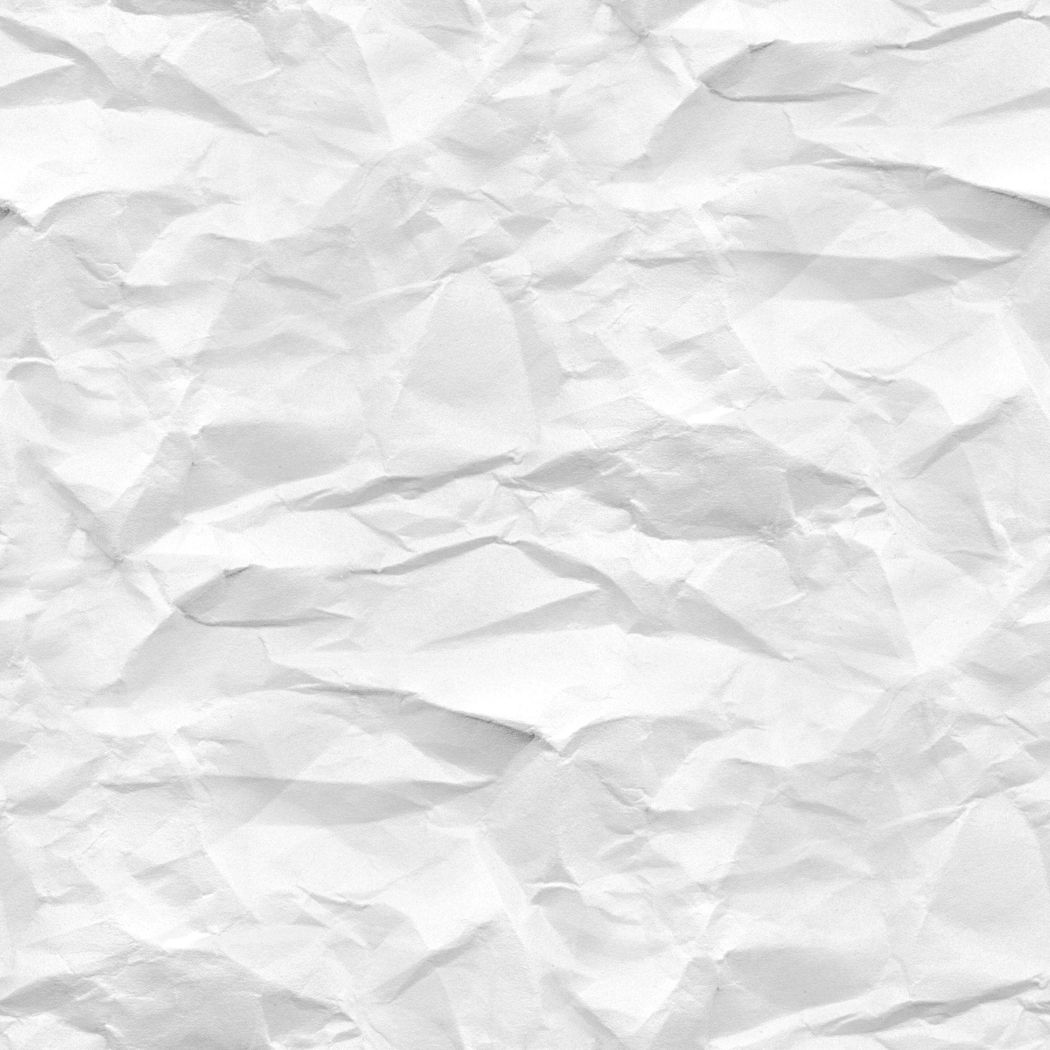 paper 桌布 壁紙 — 一張皺巴巴的白紙特寫，柔和的陰影凸顯其紋理摺痕和皺褶。