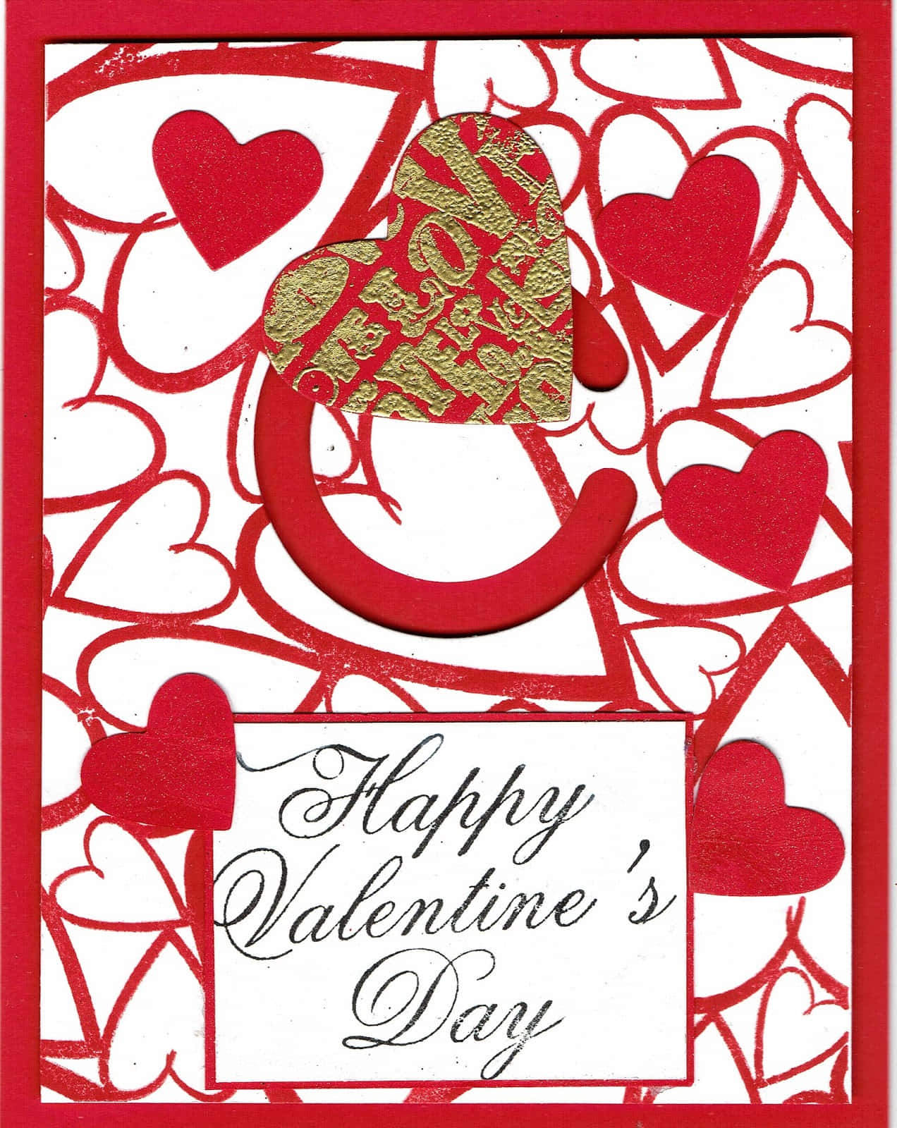 Happy Valentines 桌布 壁紙 — 一張節日情人節卡片，上面有紅色愛心和一個金色箔紙愛心，寫著「我愛你」，背景為白色。
