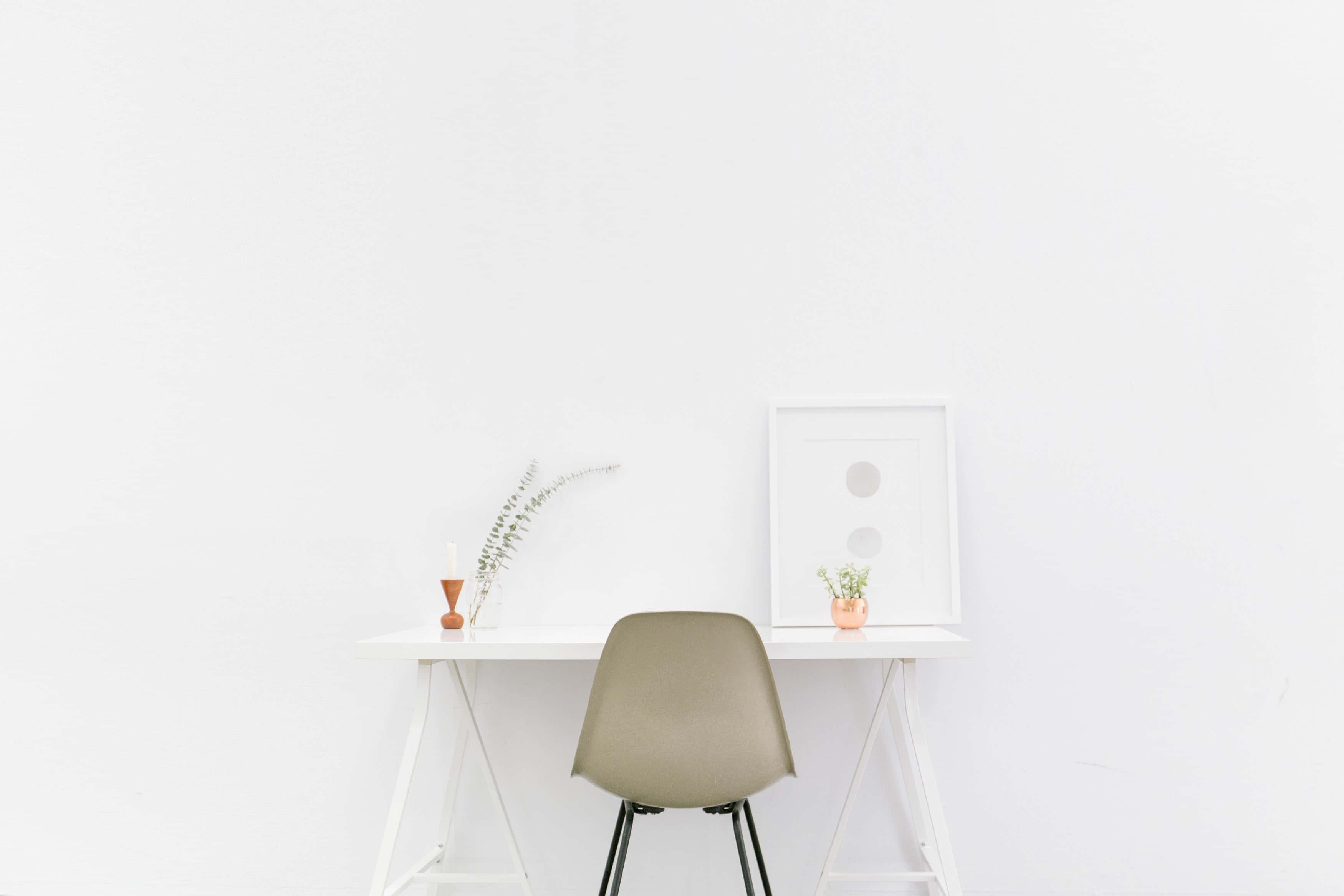 Minimalism 桌布 壁紙 — 一張簡約白色書桌，搭配米色椅子和小型盆栽植物，背景是純白牆壁。