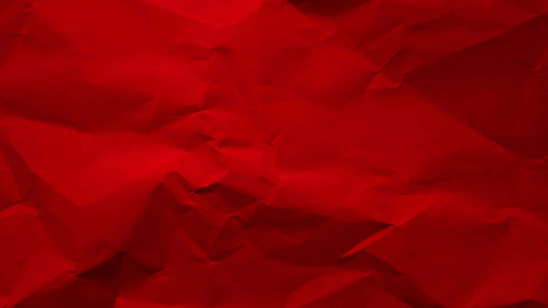Red Texture 桌布 壁紙 — 一張豐富紅色皺紙的特寫，帶有深邃陰影和高光，營造出紋理化的抽象表面。