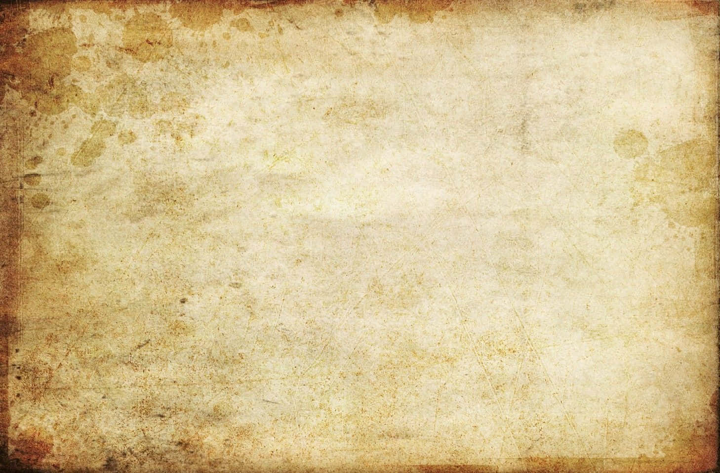 Old Paper 桌布 壁紙 — 一張風化的復古羊皮紙，帶有棕色污漬和摺痕，喚起古董手稿的感覺。