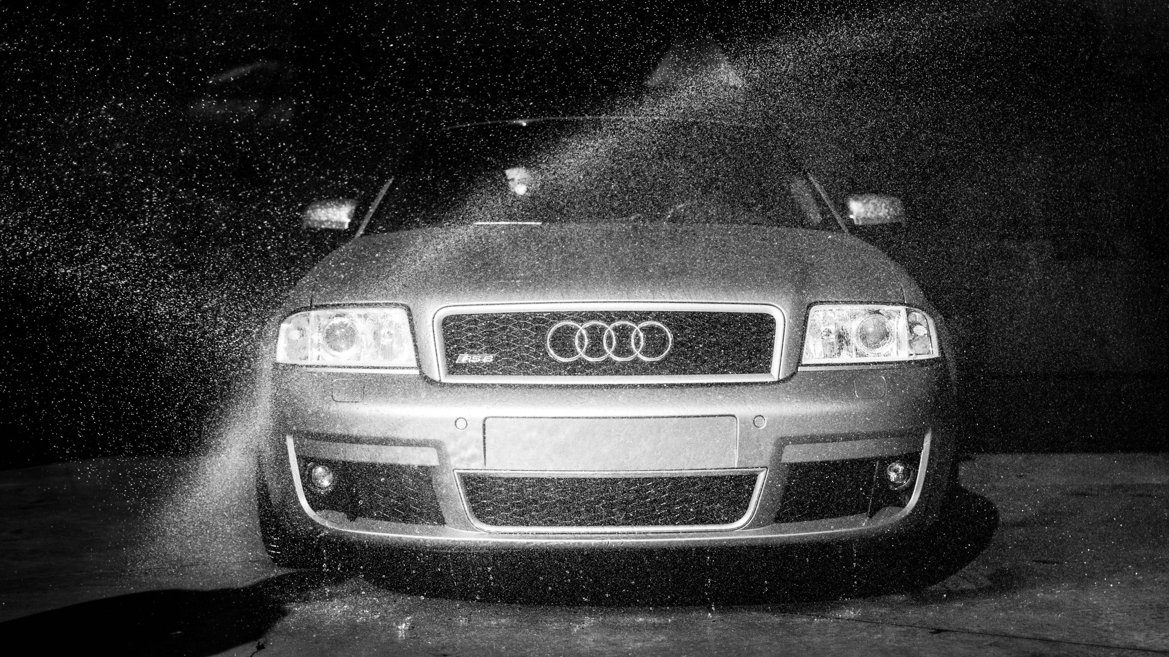 Wash 桌布 壁紙 — 一張黑白照片，拍攝一輛銀色奧迪汽車在夜間被水噴灑，水滴在黑暗背景中定格。