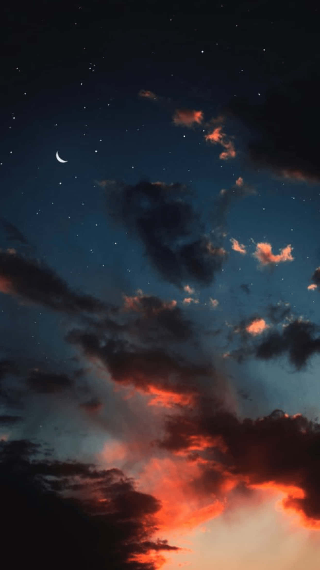 Aesthetic Night Sky 桌布 壁紙 — 一彎新月和星星在散發著火橙色和深藍色暮光的雲層上方閃耀。