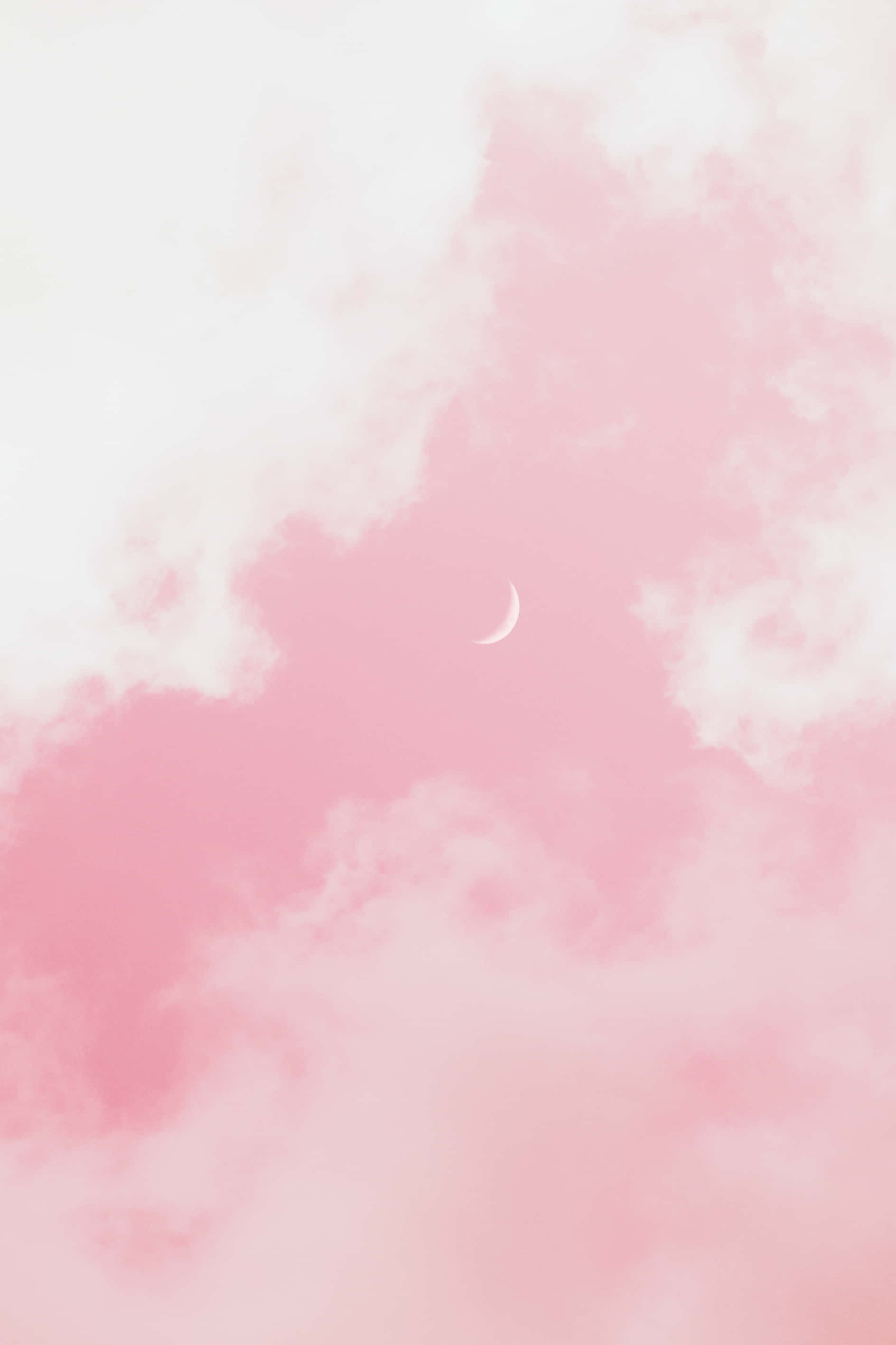 Pink Phone 桌布 壁紙 — 一彎精緻的月牙在夢幻的粉白雲空中柔和發光。